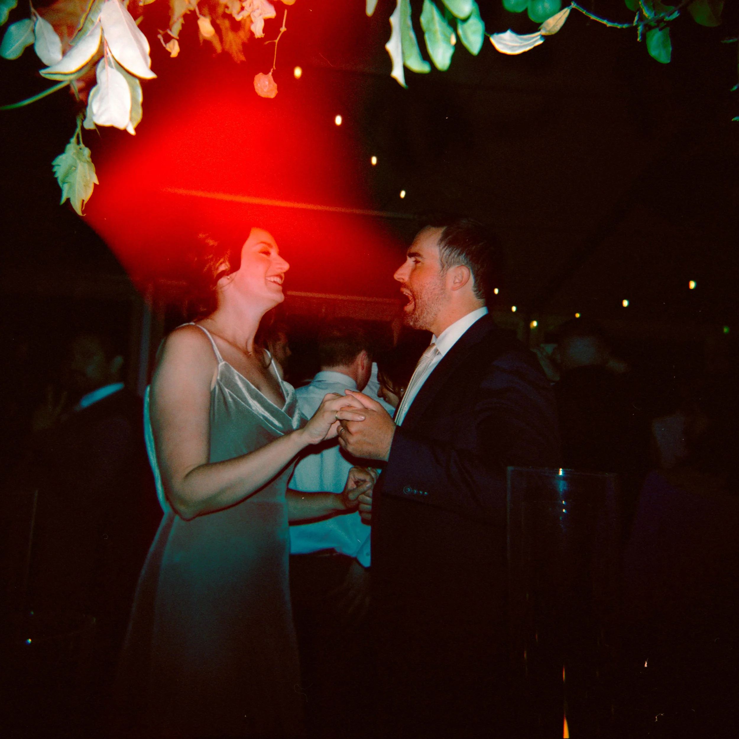 LBW122-wedding-guests-dancing-at-reception-holga.jpg