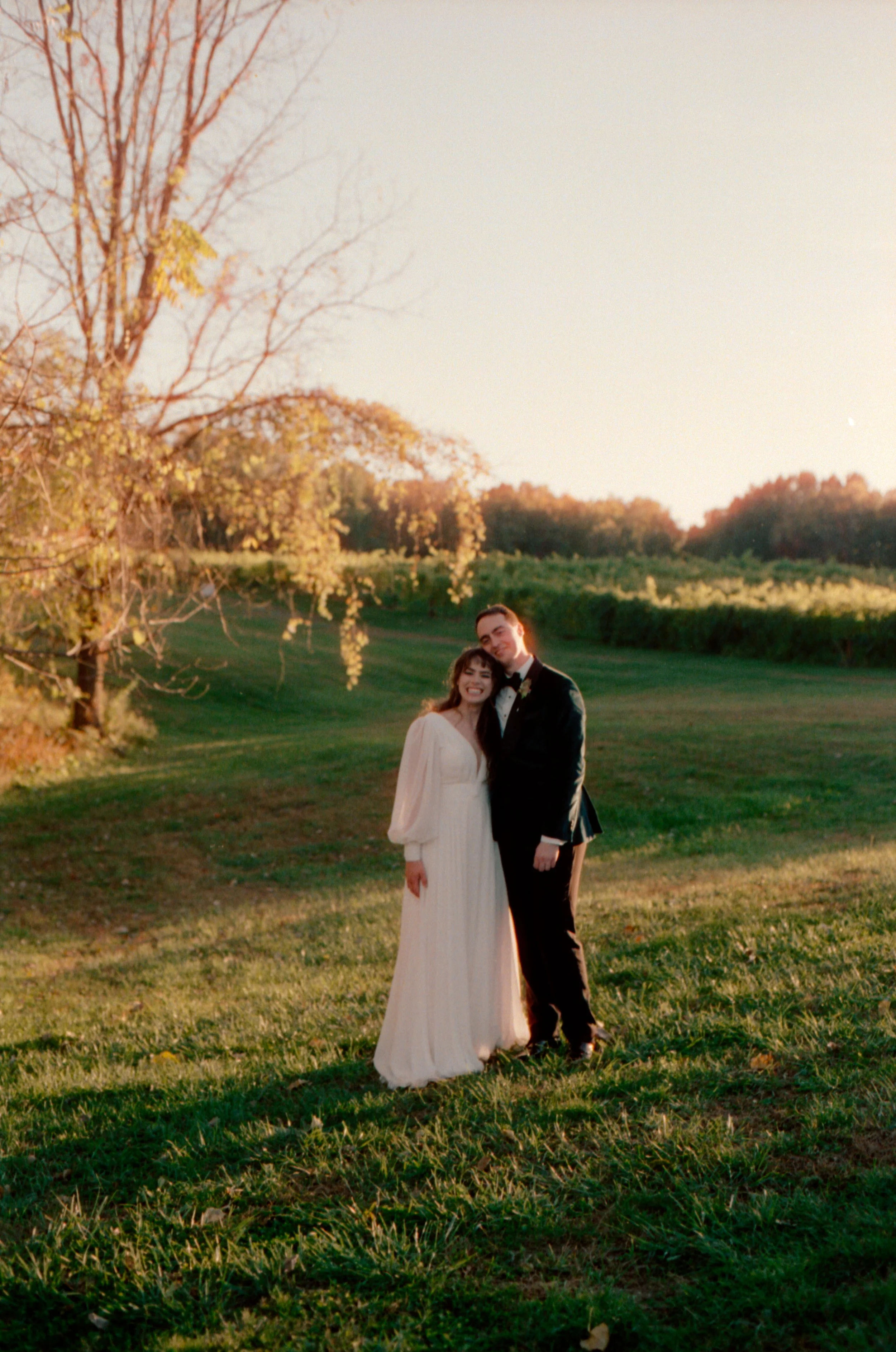 LBW105-bride-groom-posing-smiling-at-sunset.jpg
