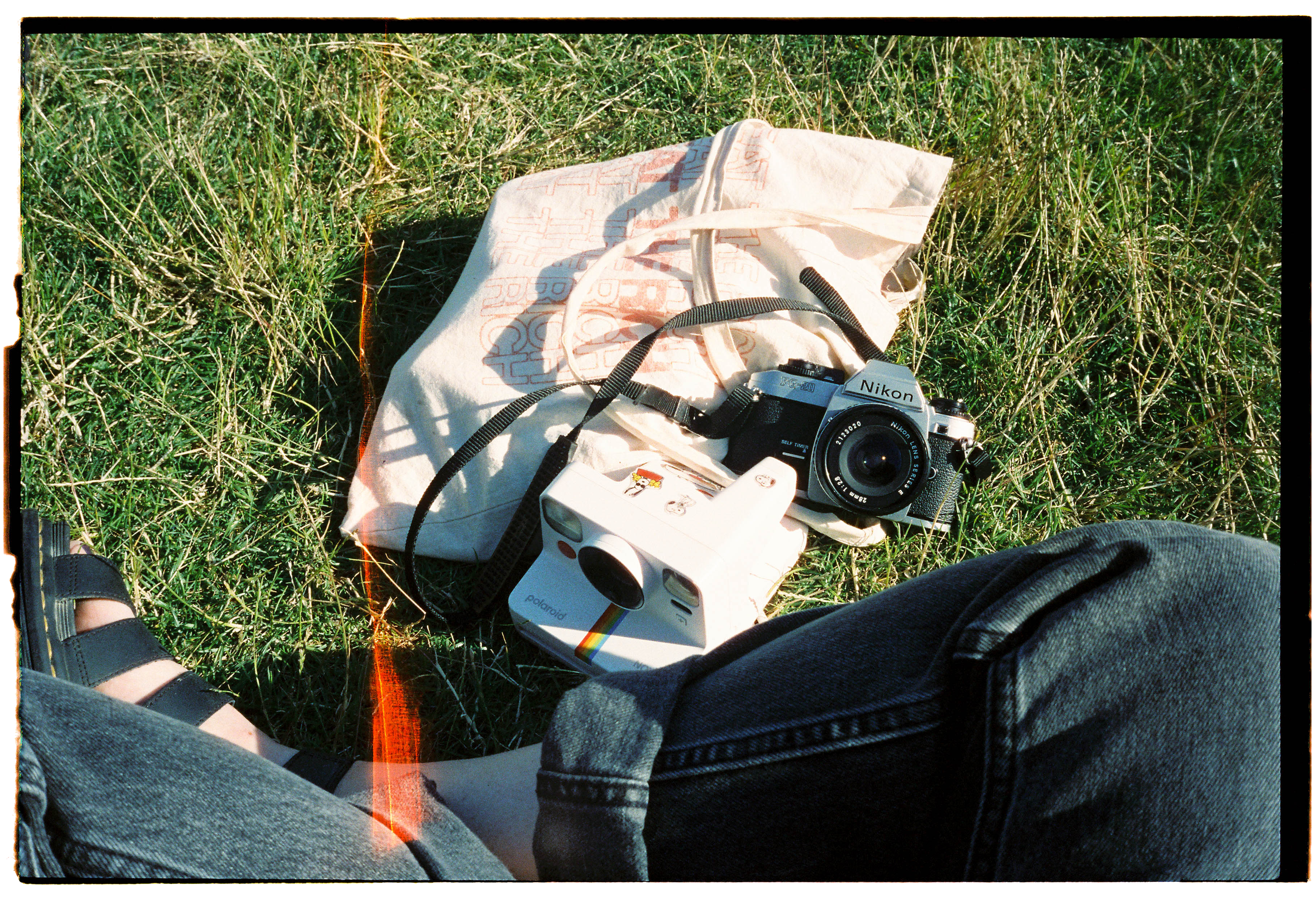 pnw197-polaroid-tote-bag-camera-on-grass.png