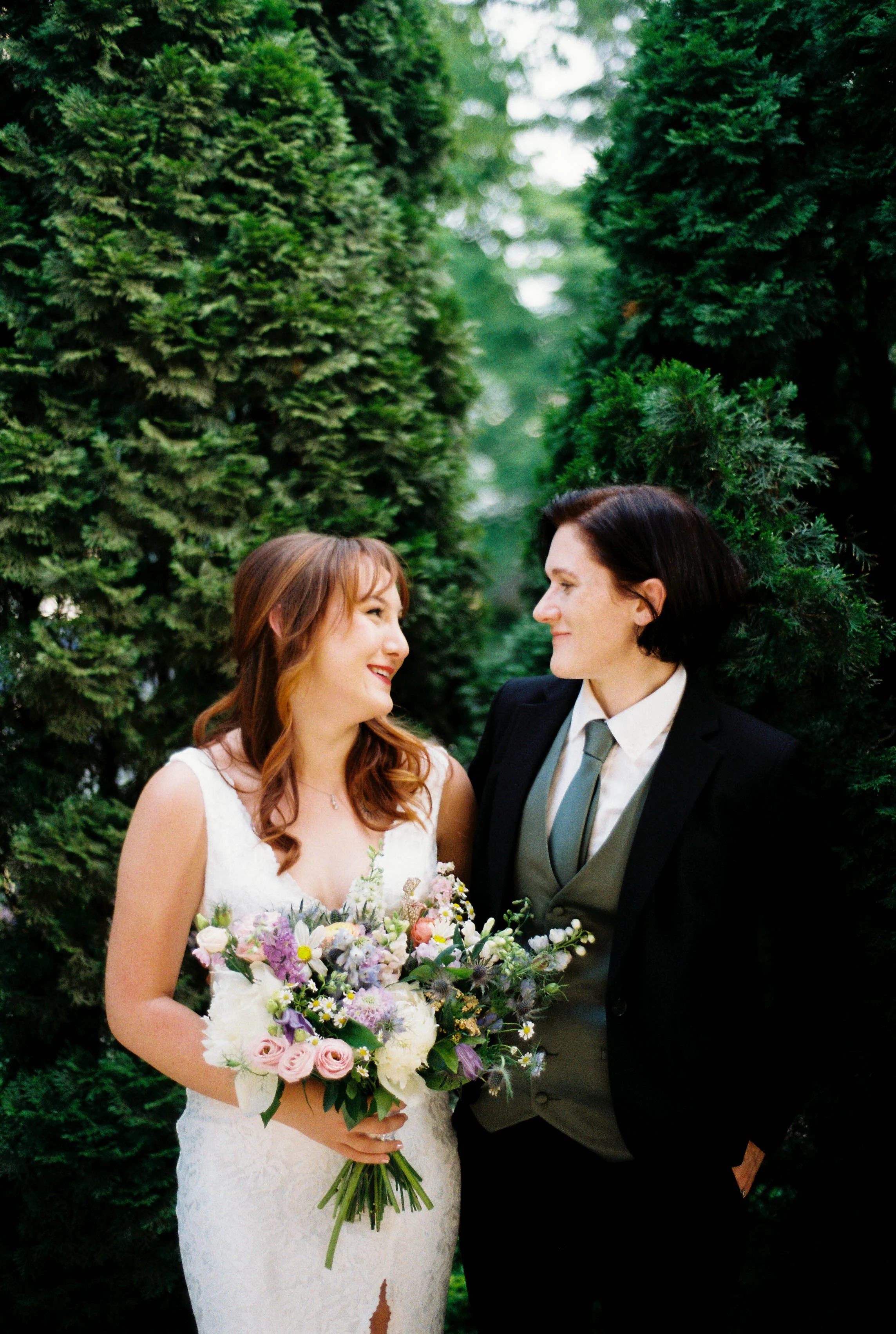 HRF49-brides-smiling-at-each-other-lgbtq-wedding.jpg