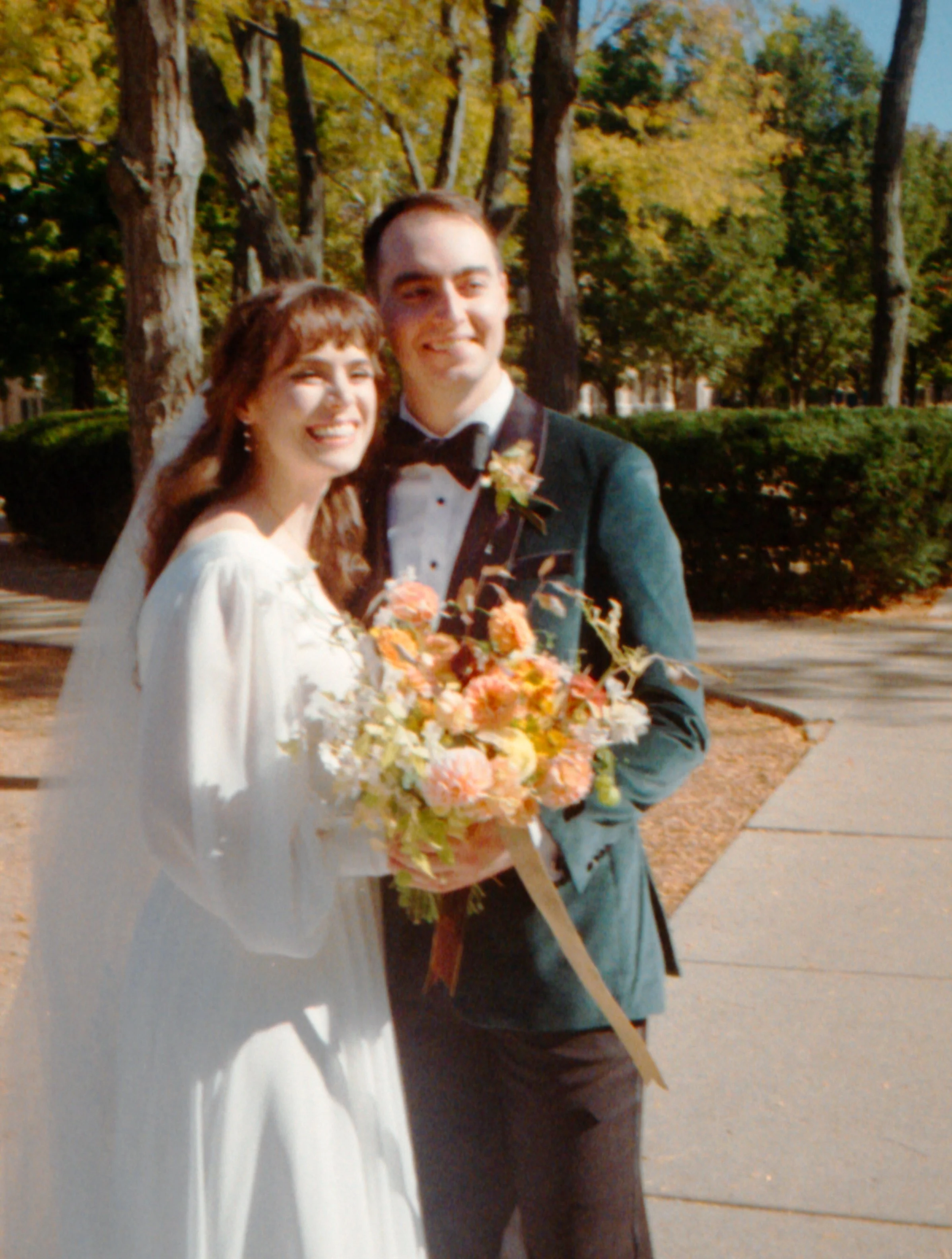 LBW27-bride-groom-together-smiling-flower-bouquet.jpg
