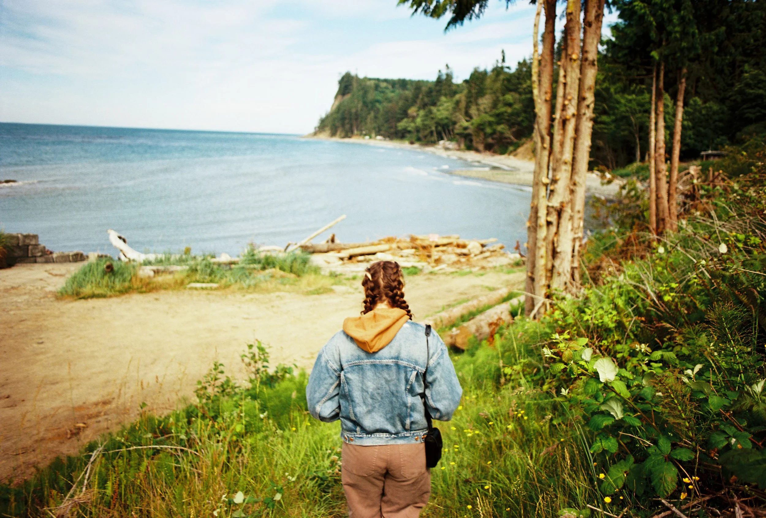 pnw156-woman-hiking-by-water-jean-jacket.jpg