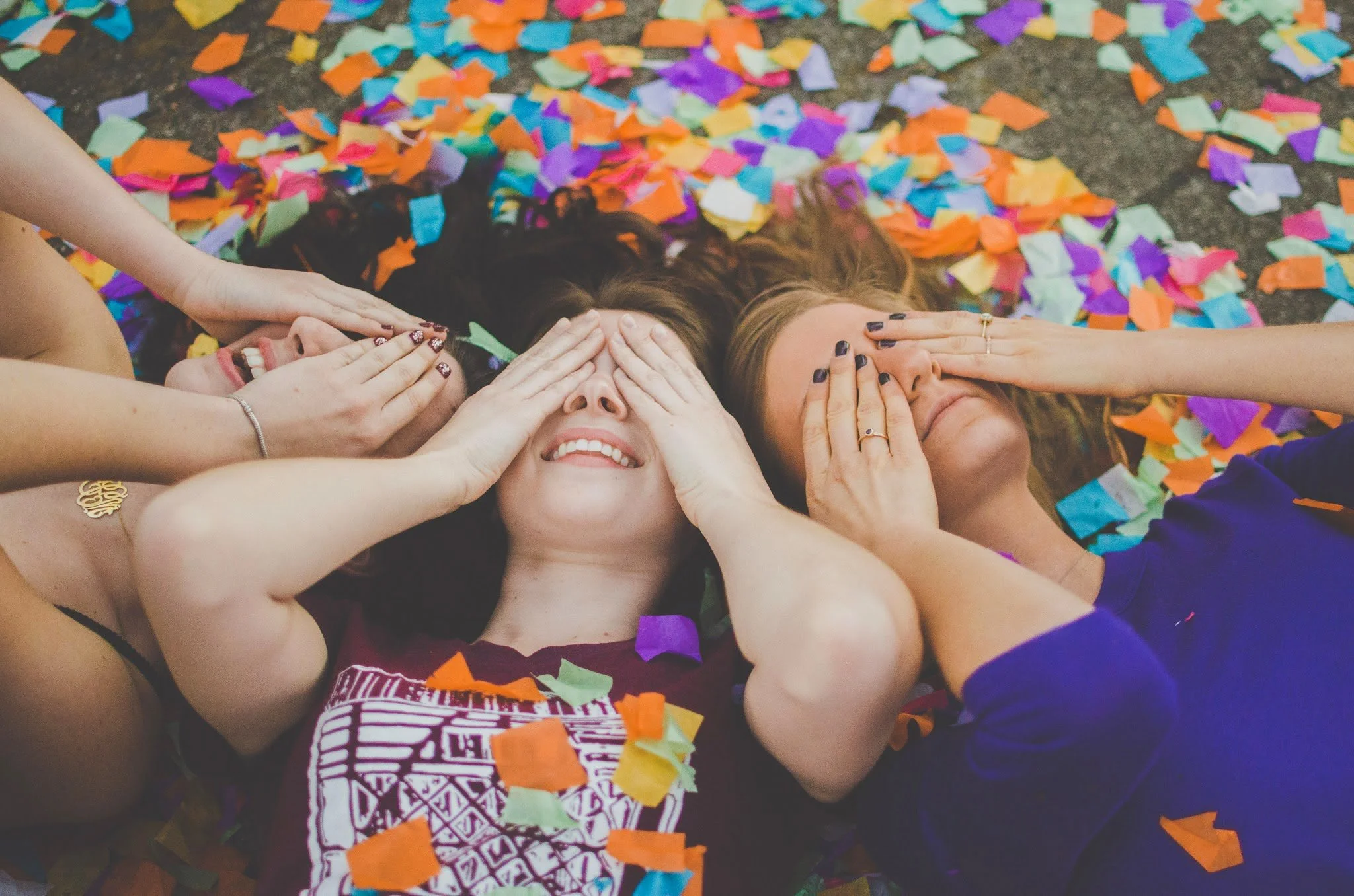 d17-women-covering-faces-with-confetti.jpg