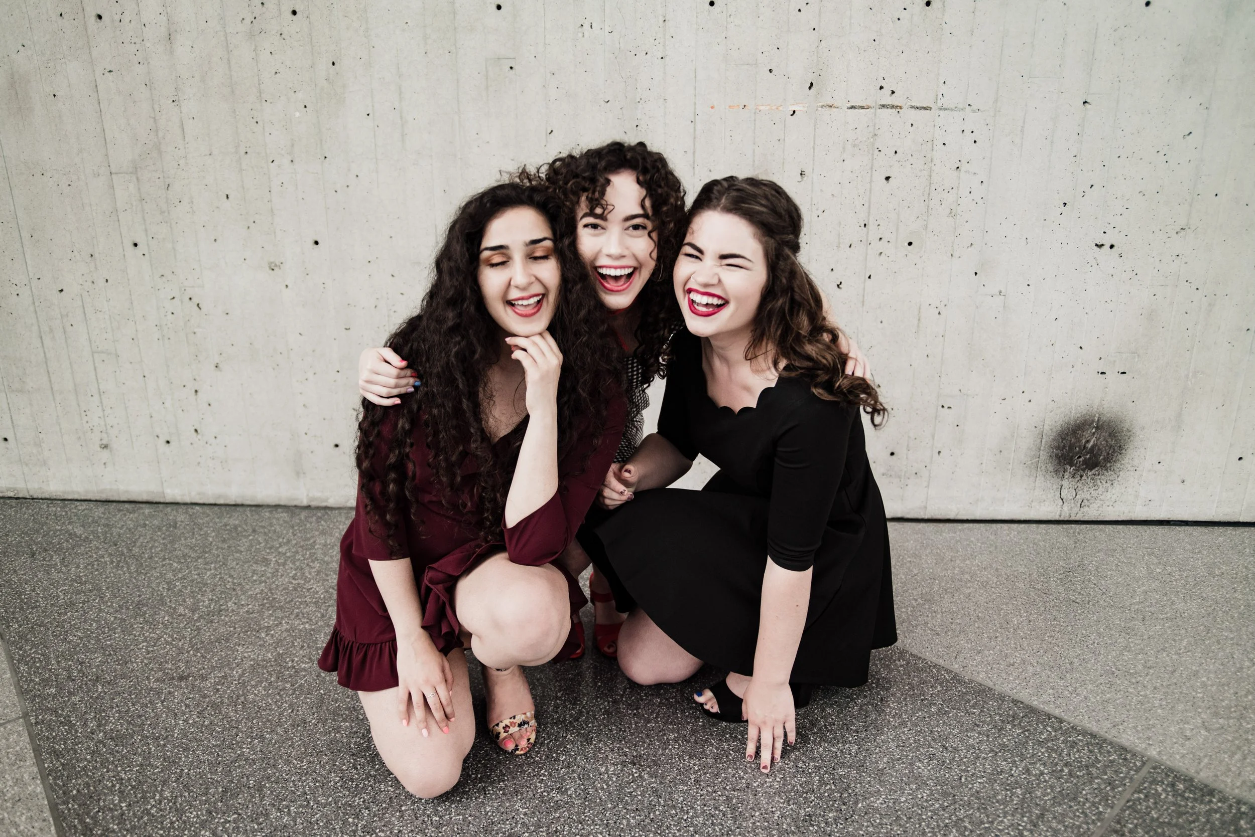 BT301-three-women-laughing-on-ground.jpg