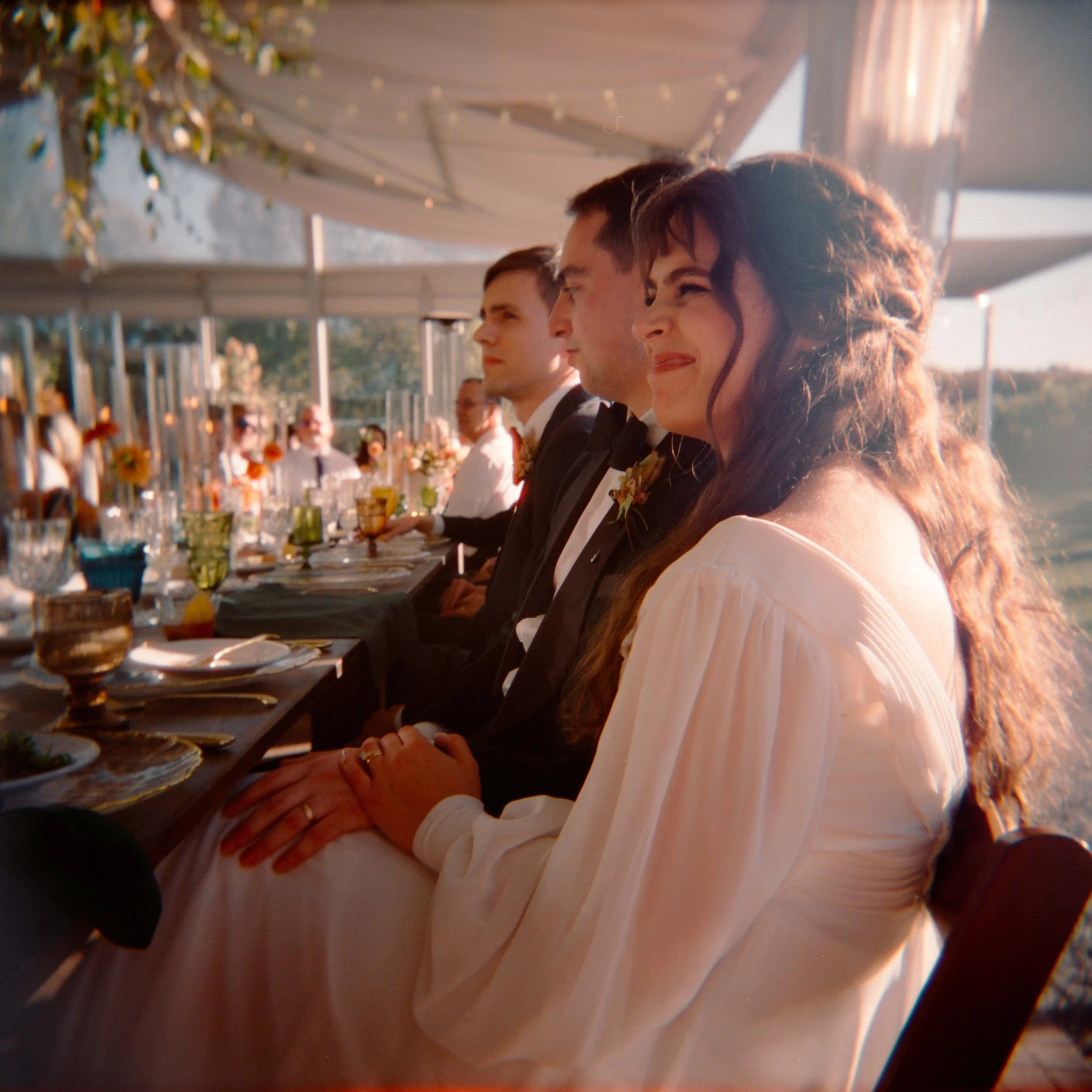 LBW92-bride-smiling-at-toast-on-holga.jpg