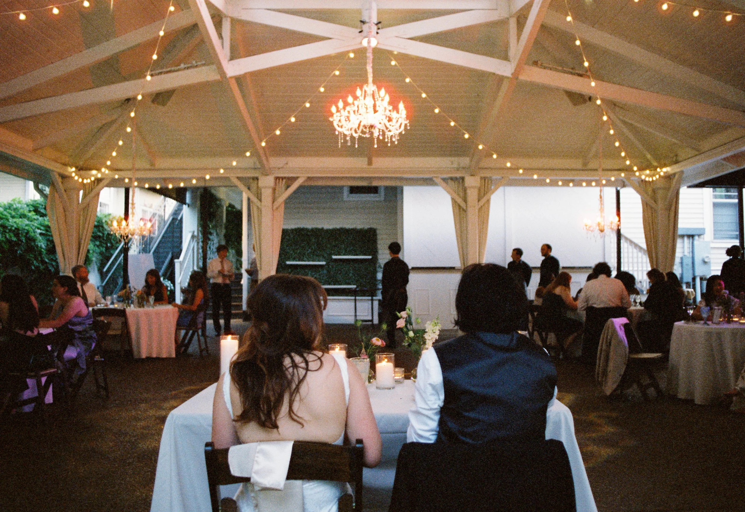HRF73-brides-sitting-at-table-at-wedding-reception.jpg