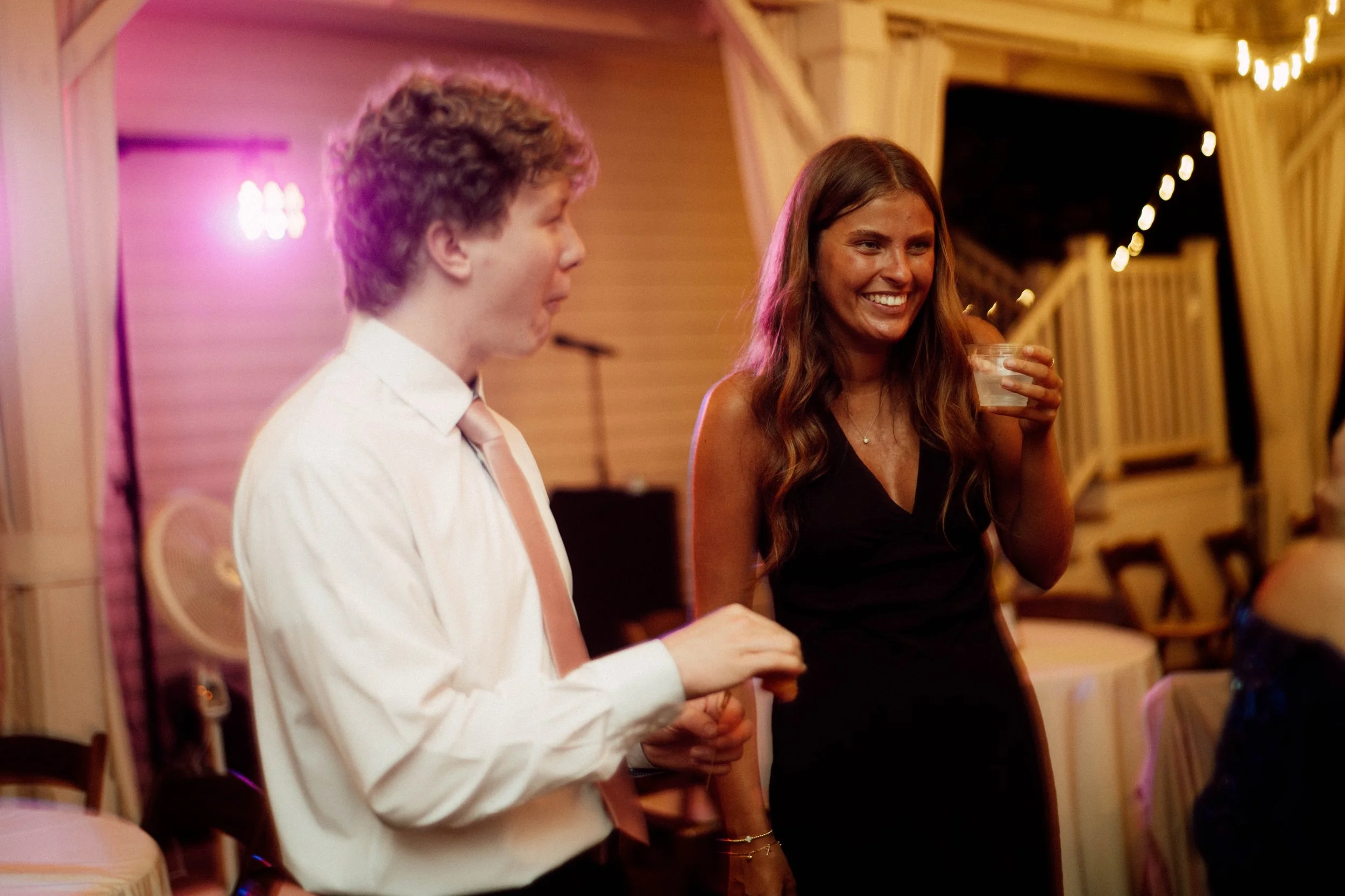 HRD93-women-holding-drink-smiling-on-dance-floor.jpg