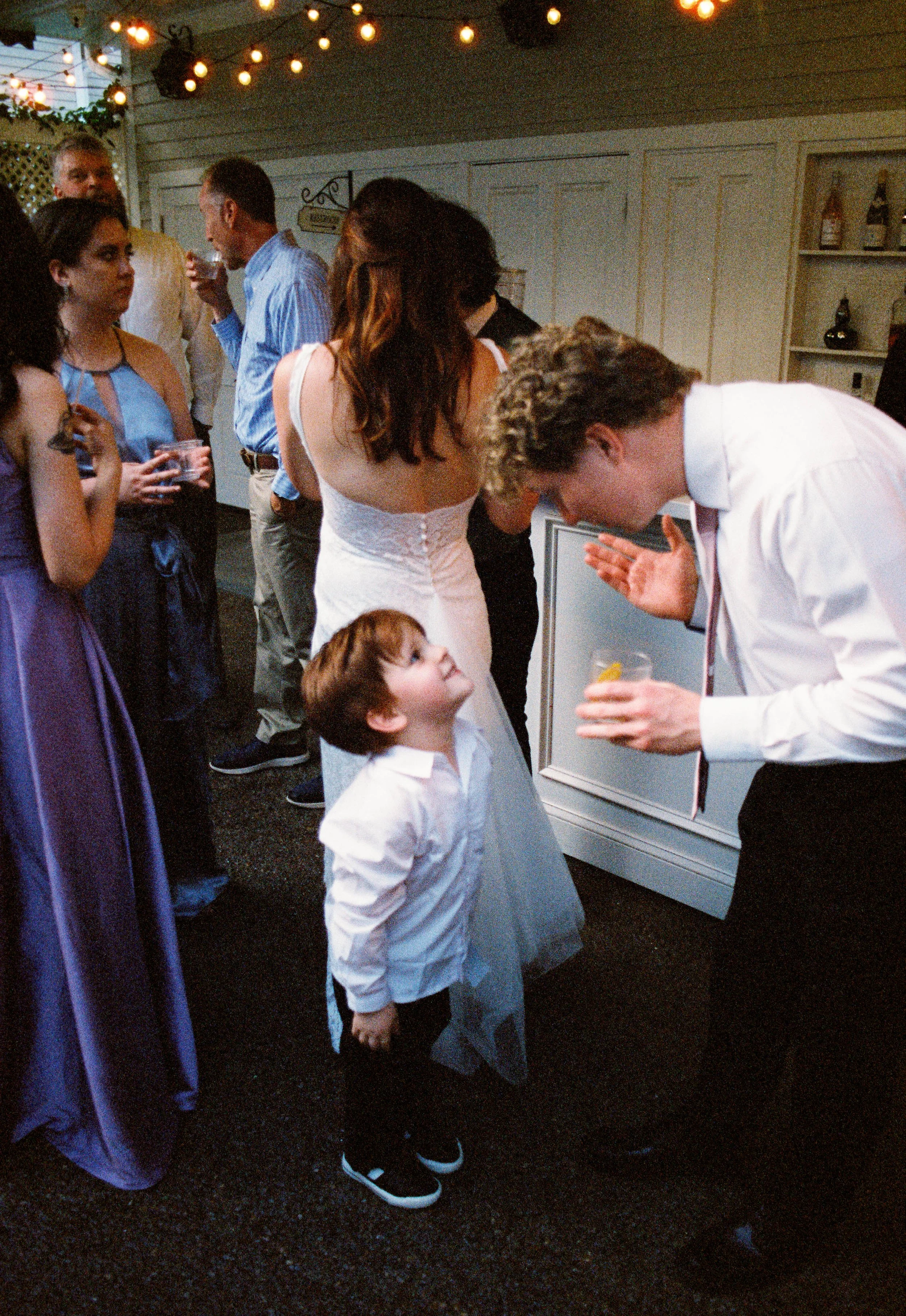 HRF77-little-boy-talking-to-groomsman-at-wedding.jpg