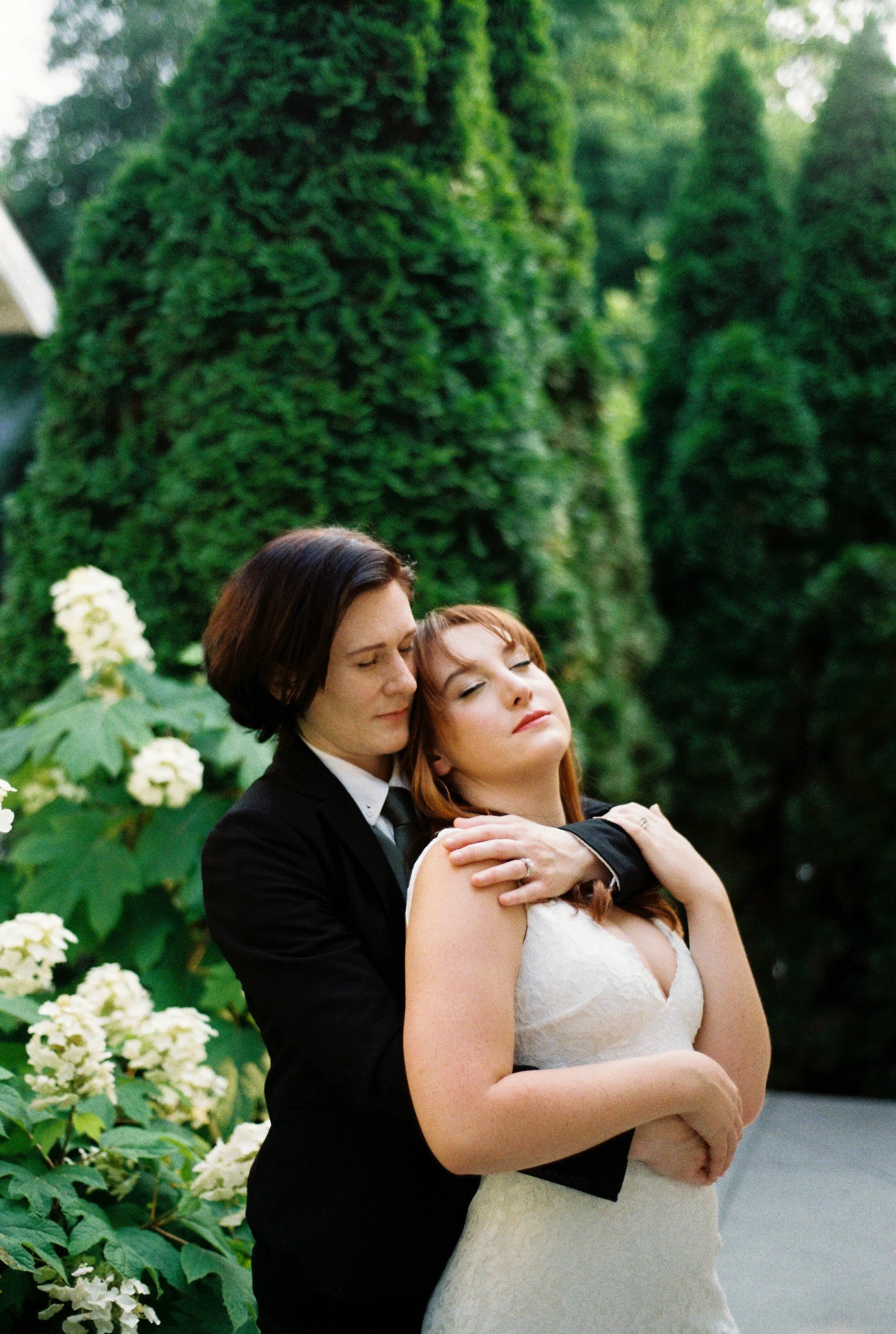 HRF57-queer-brides-holding-each-other-flowers.jpg