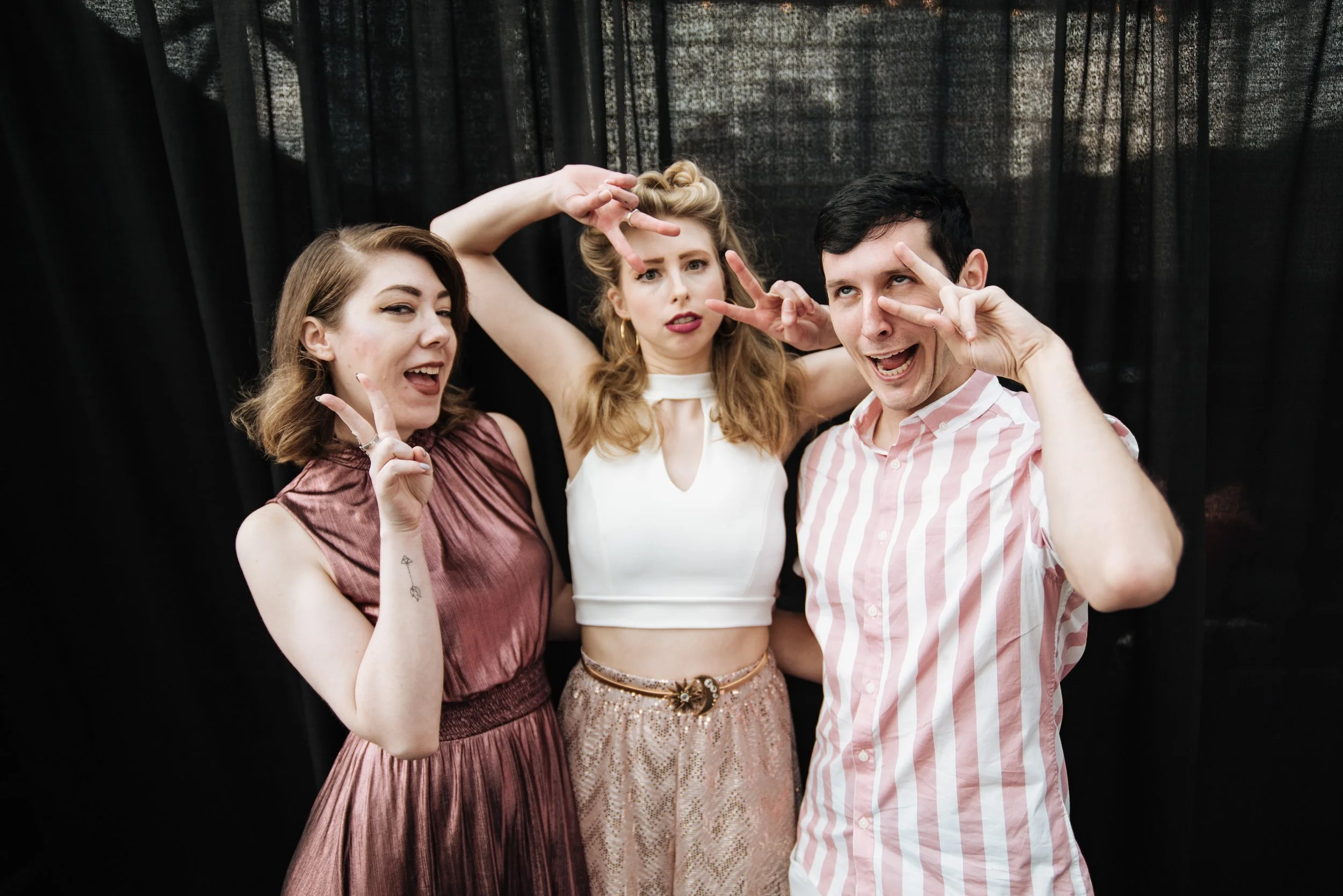 BT453-three-people-funny-faces-black-background.jpg