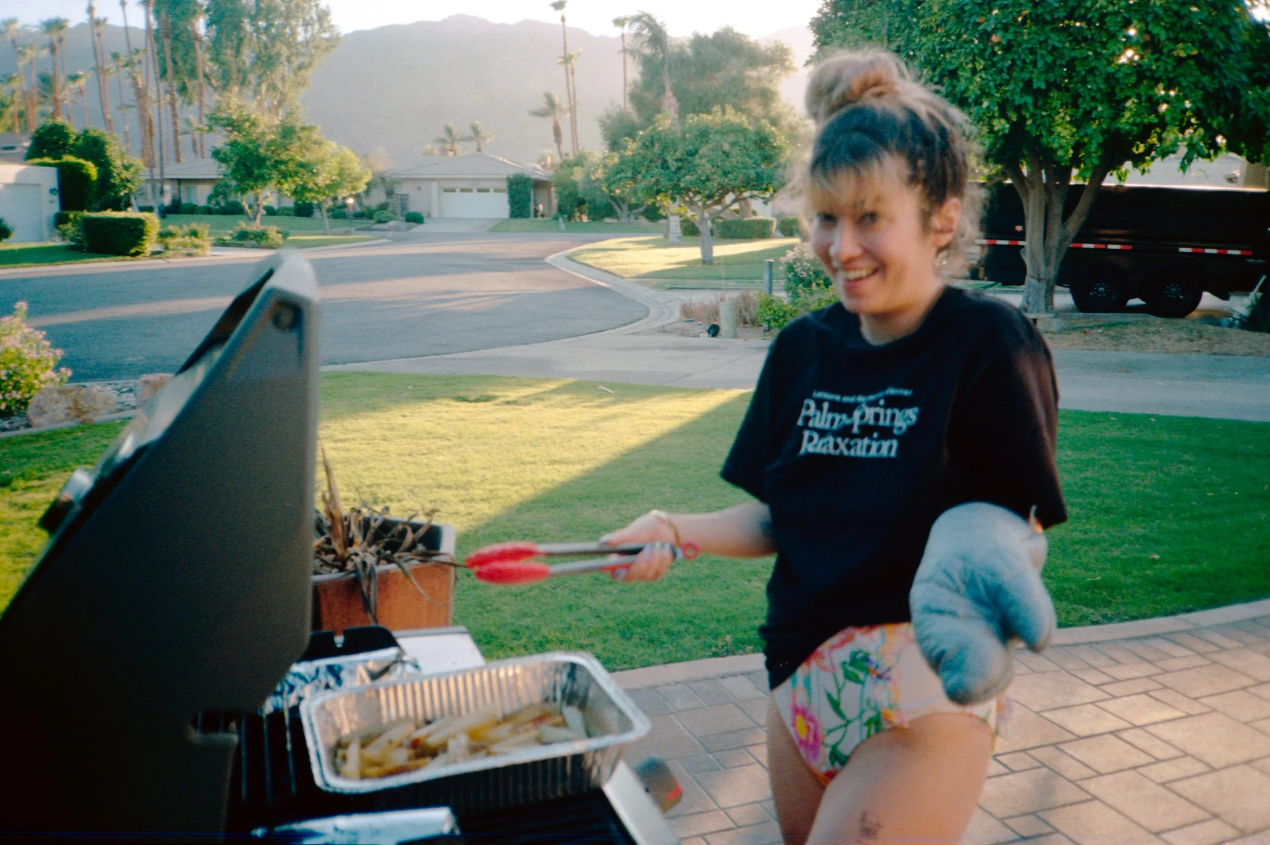 BT64-woman-with-oven-mit-cooking-at-grill.jpg