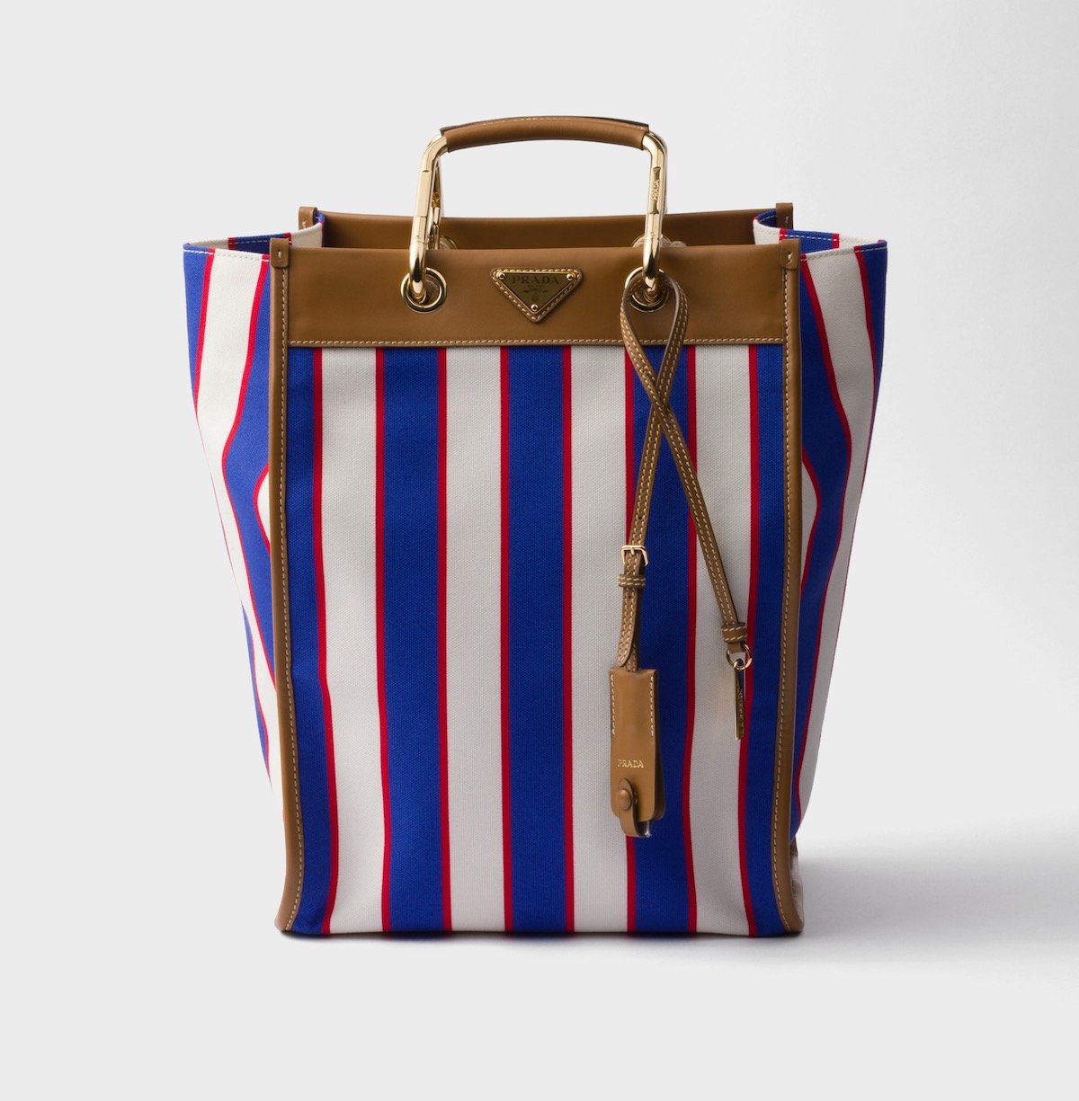 Prada Large Printed Canvas and Leather Tote Bag in Royal Blue/Caramel, $3,350 at Prada