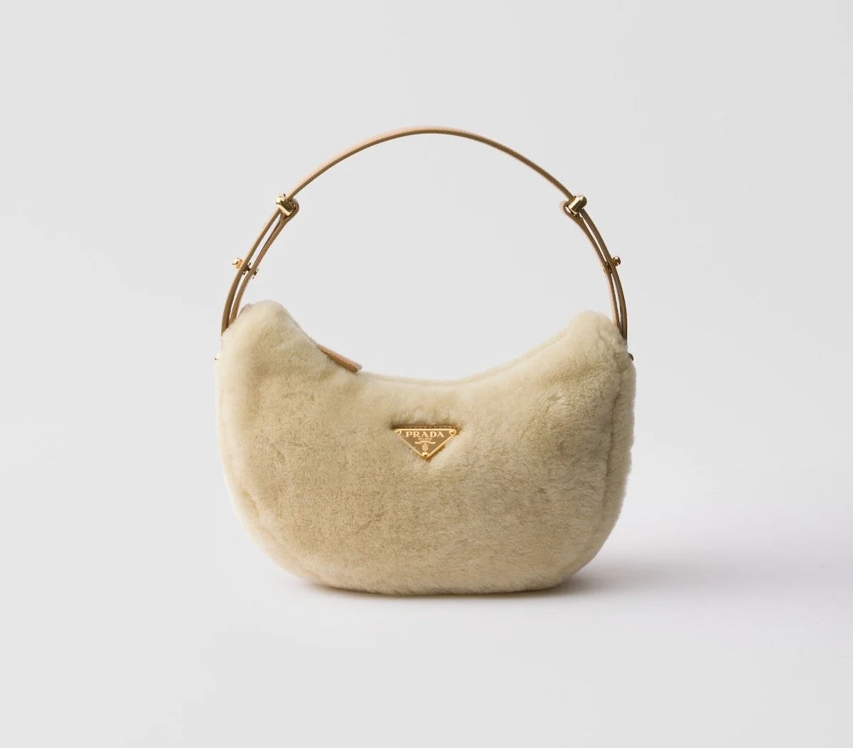 Prada Arqué Shearling and Leather Shoulder Bag, $3,450 at Prada