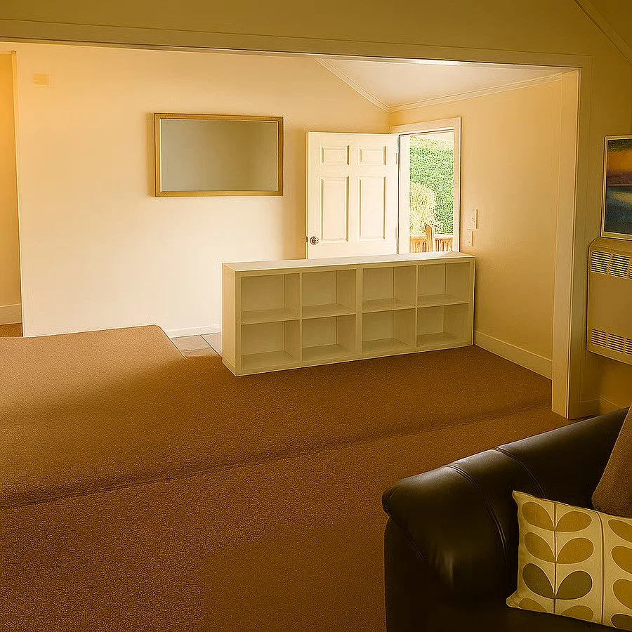 Quiet, light-filled living space with comfortable seating and a functional layout for extended stays.