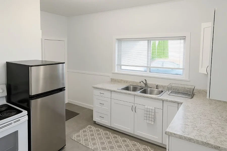 Fully equipped kitchen with full-sized appliances, cookware, and ample storage and space for everyday cooking