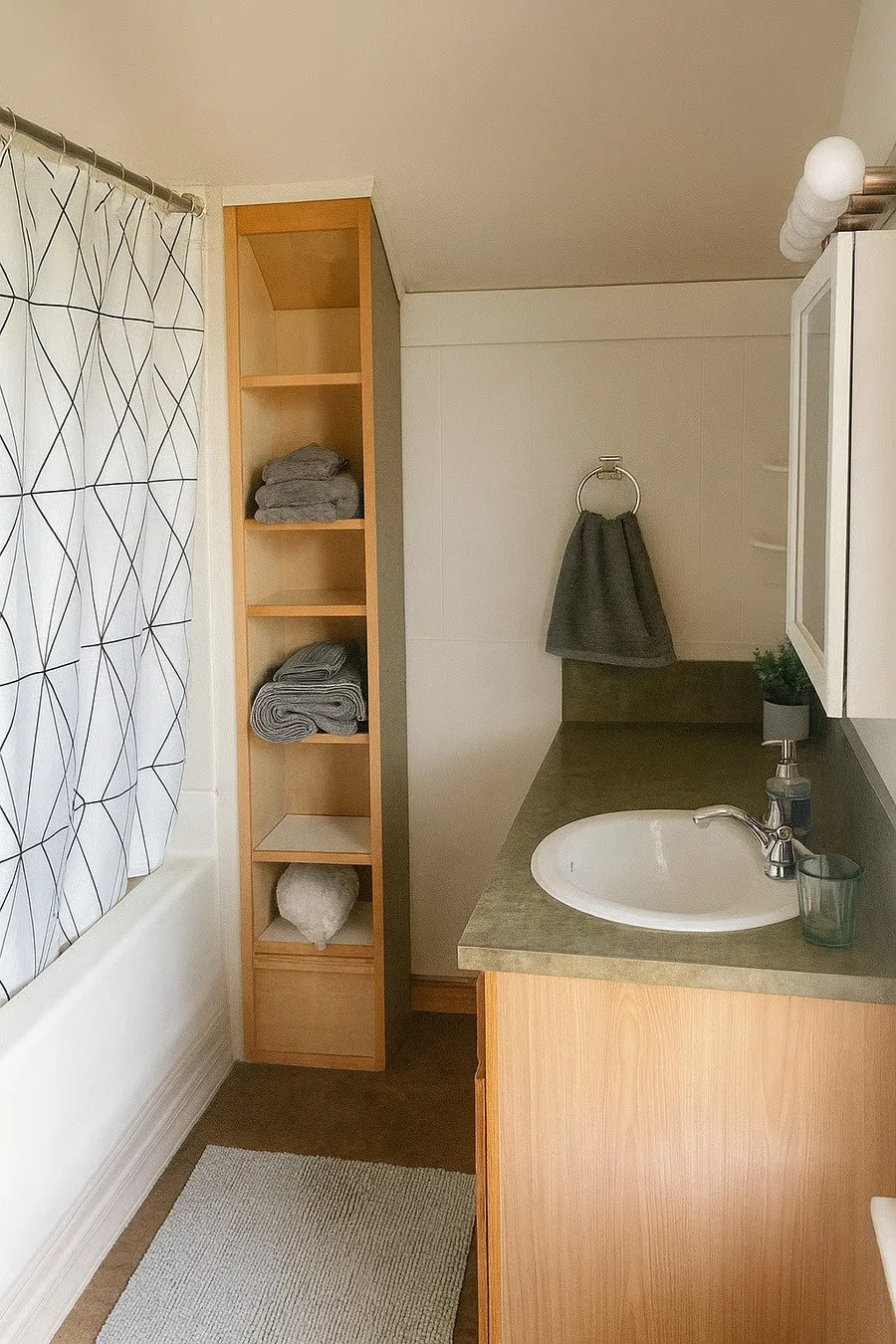 Clean, well-maintained bathroom with tub/shower combo and fresh towels provided.