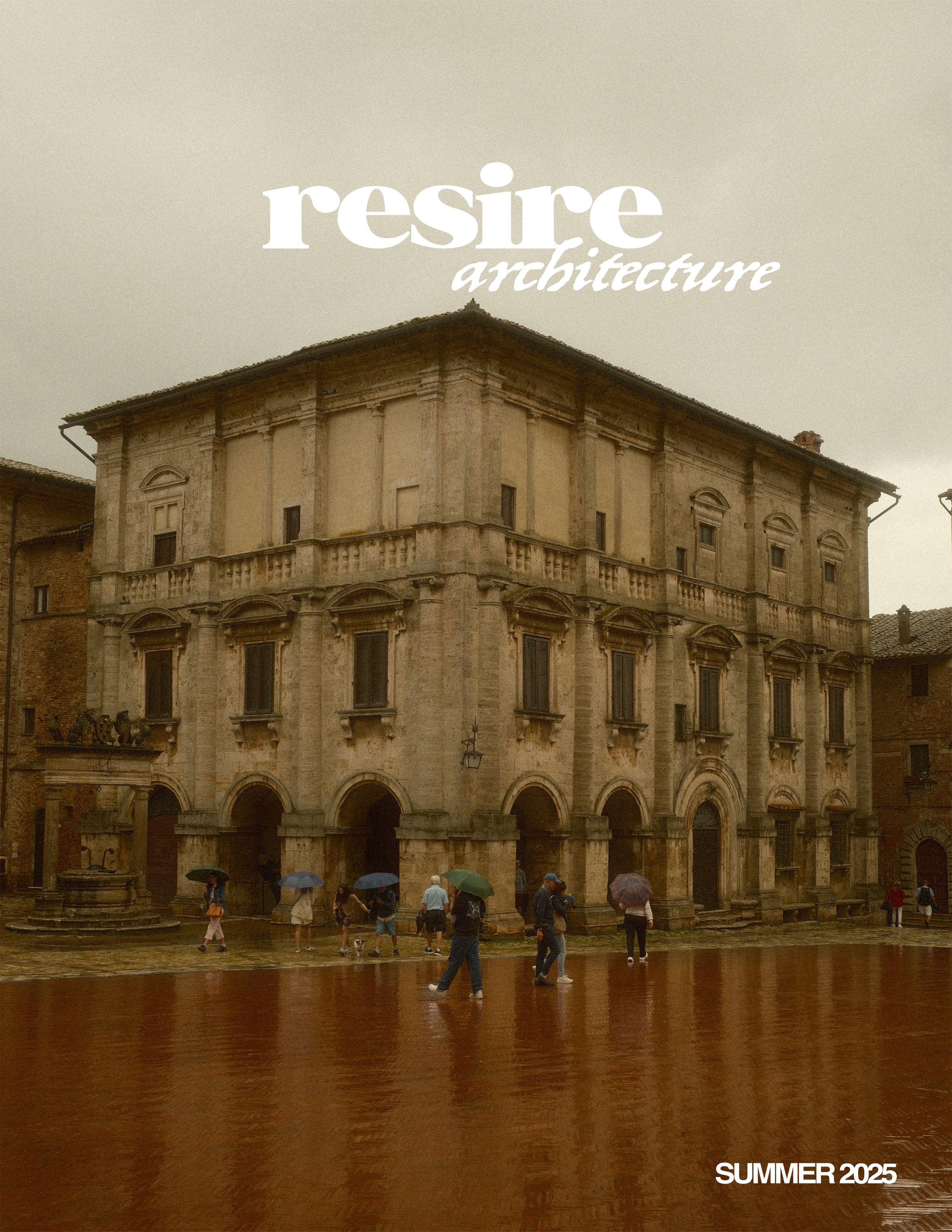 People with umbrellas walking in front of an old stone building on a rainy day.