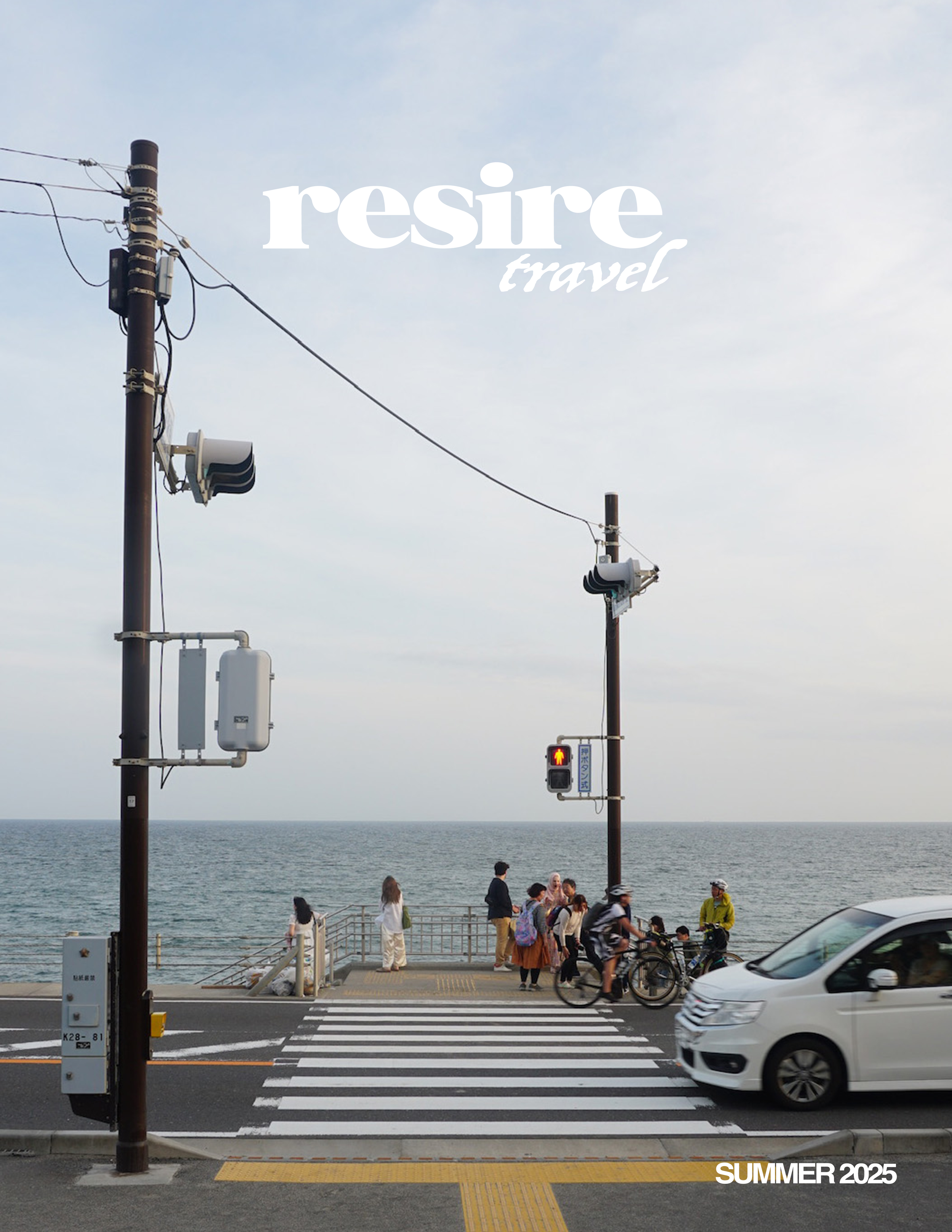 A coastal street scene with a crosswalk leading to a pedestrian walkway by the ocean, featuring people and cyclists waiting to cross, traffic lights, and power lines, with a promotional text overlay for 'resire travel' and 'SUMMER 2025'.