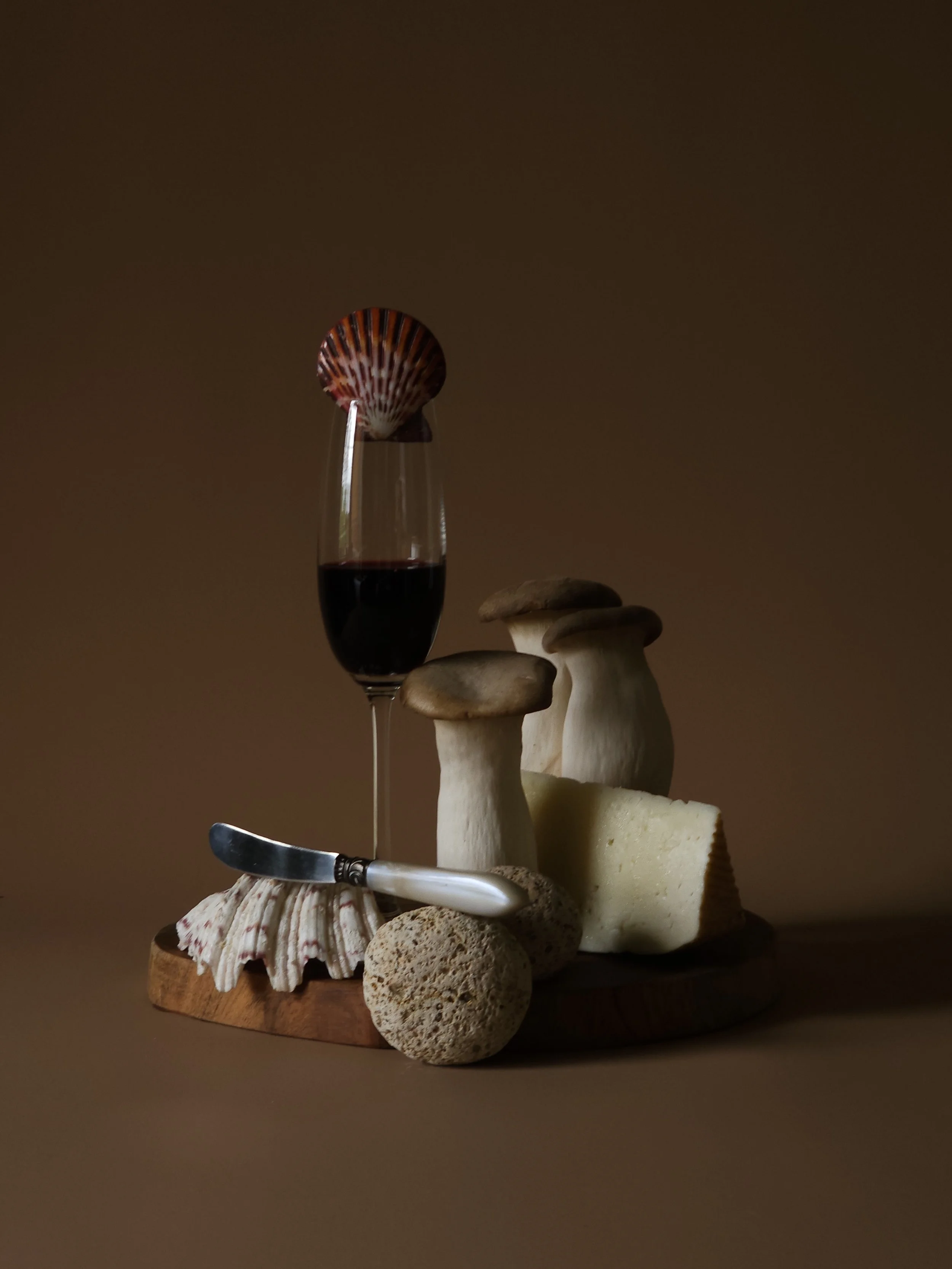 Creative still life with glass of red wine, cheese and food 