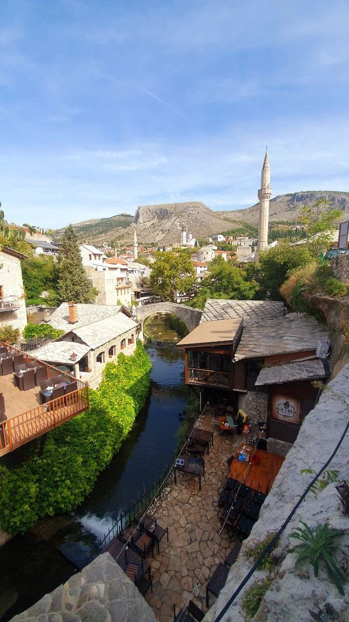 The rebuilt stone bridge and landscape of Mostar, Bosnia and Herzegovina, representing cultural attachment and intergenerational trauma healing.