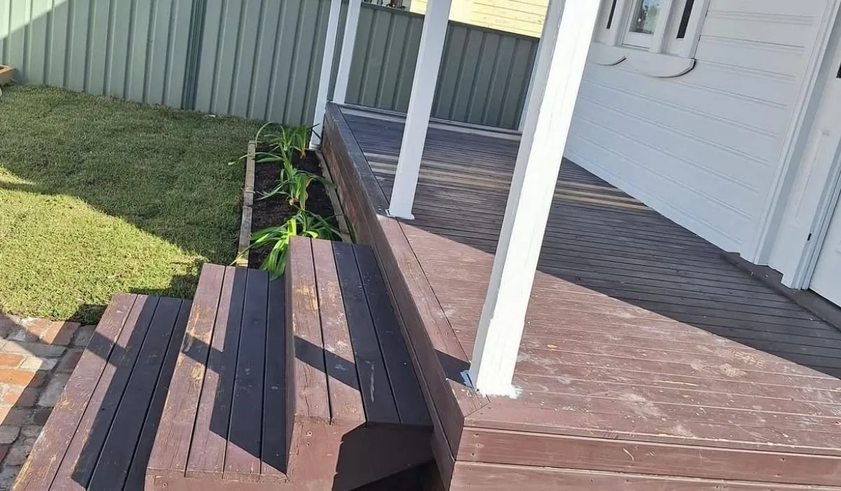 Timber front deck before repainting, showing worn brown boards in Newcastle