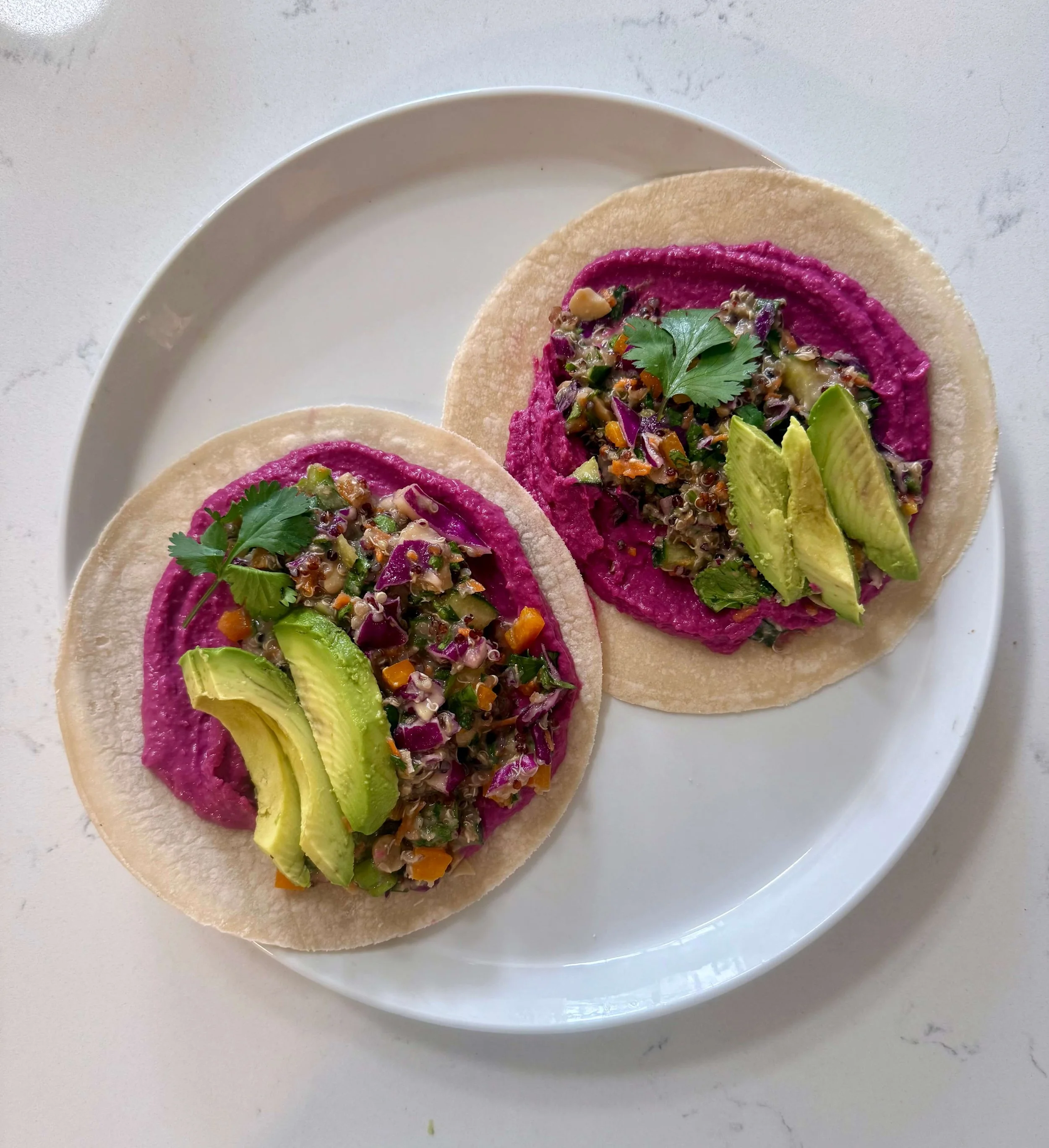 this is an image of a veggie quinoa wrap featuring zesty beet navy bean dip