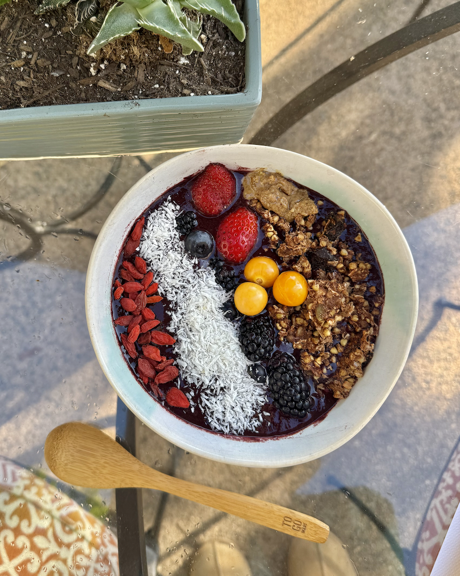 Creamy white bean smoothie bowl made with blueberries, cherries, kale, and chia seeds, topped with fruit and seeds