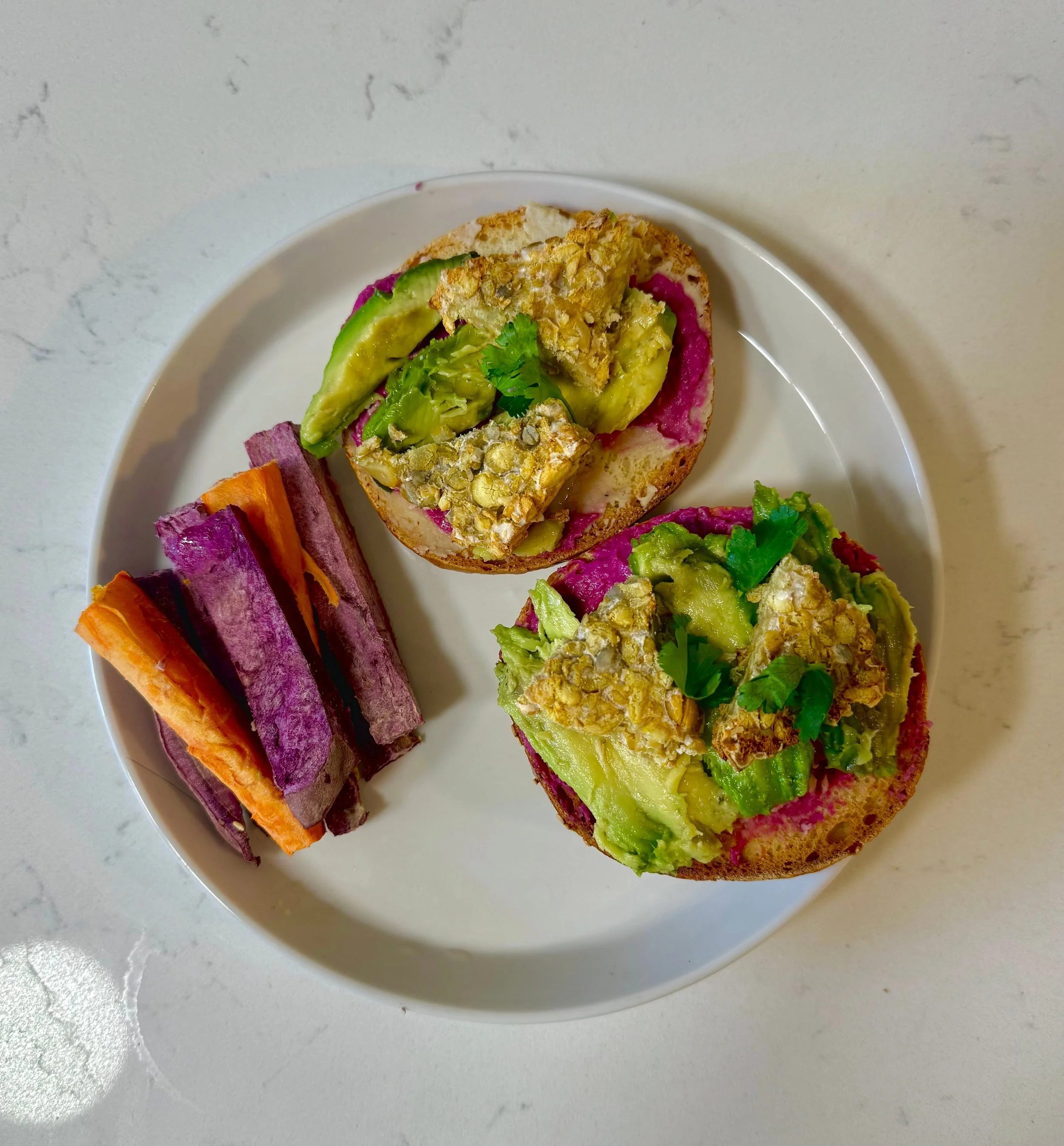 a breakfast sandwich with bean dip and tempeh