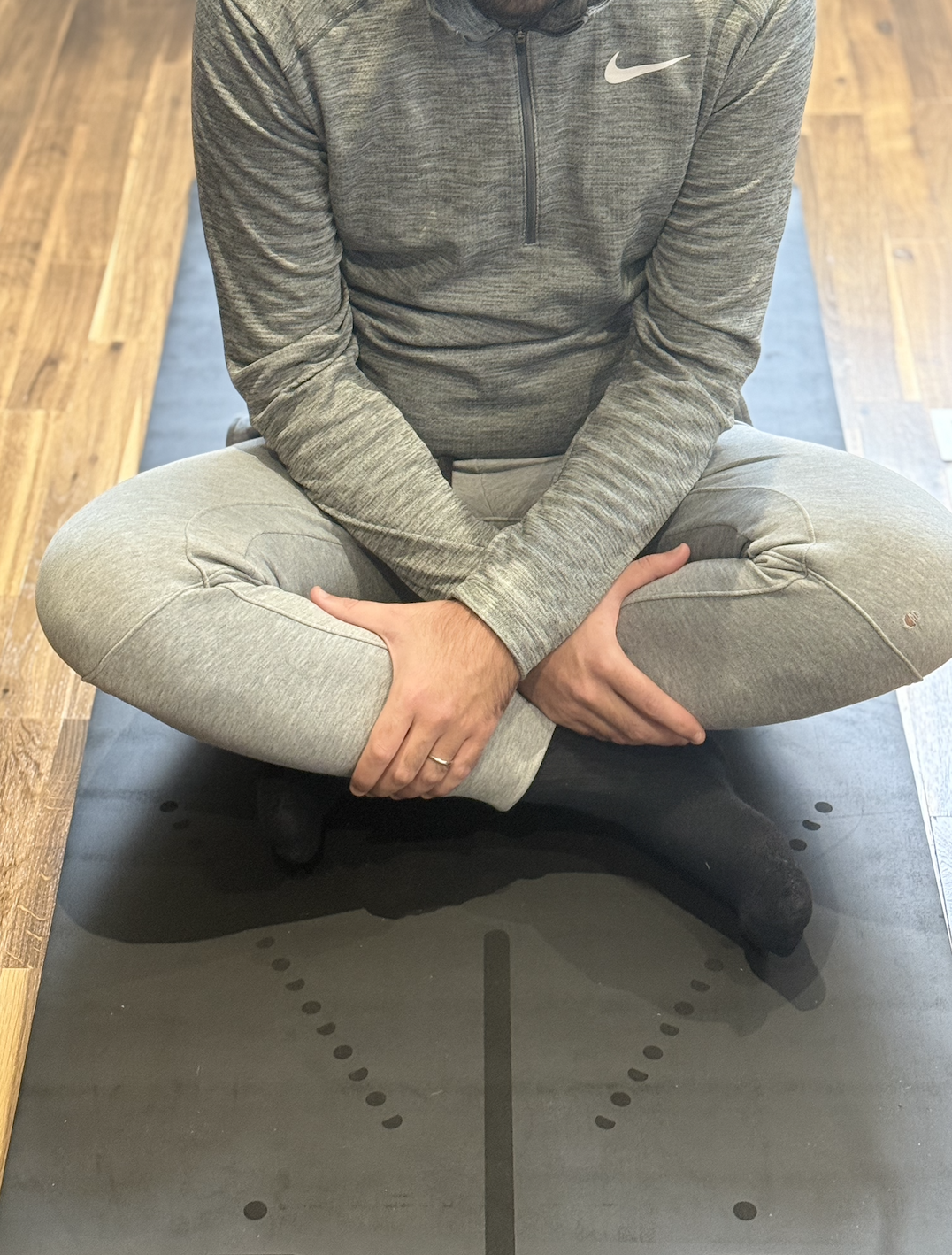 A male is doing some pelvic floor exercises sitting