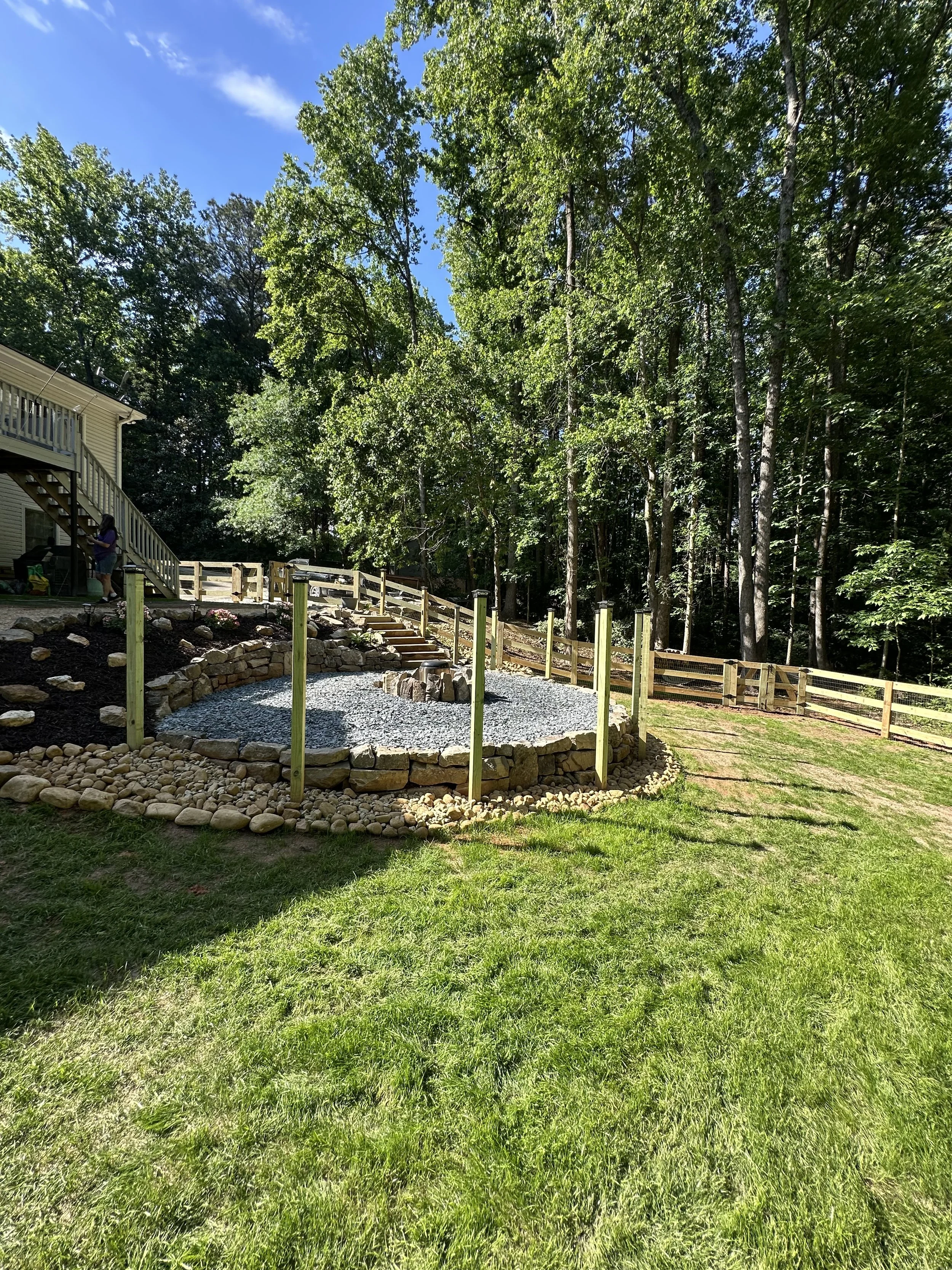 Outdoor fire pit area with 3 board ranch rail fence