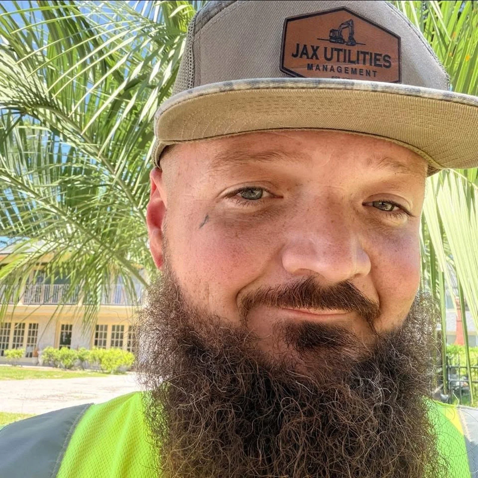 Portrait of Matthew Collins outdoors wearing a Jax Utilities Management hat.