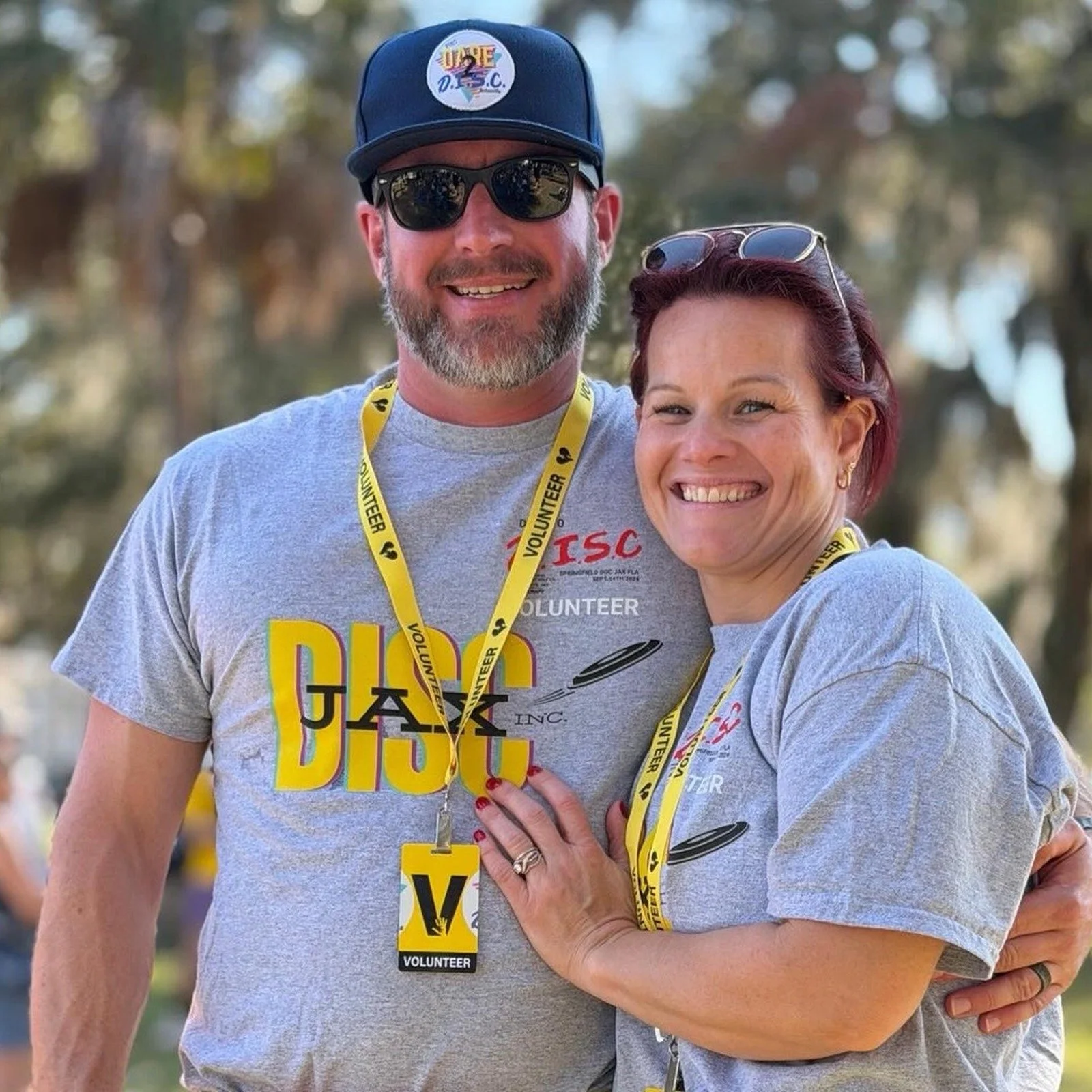 Joe Biederman smiling outdoors at a DISC Jax event with another volunteer.