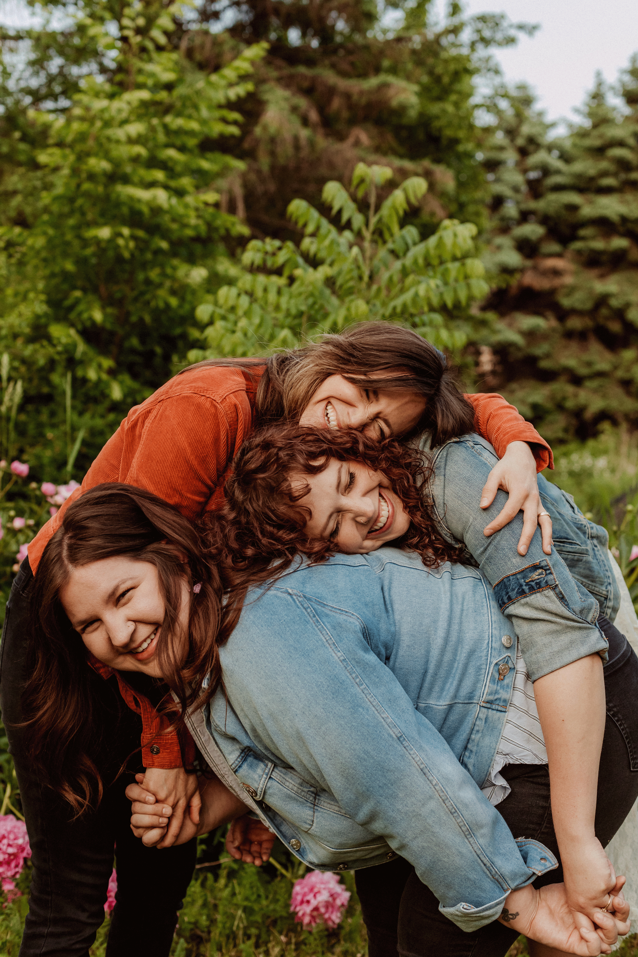 Three girls laughing and hugging