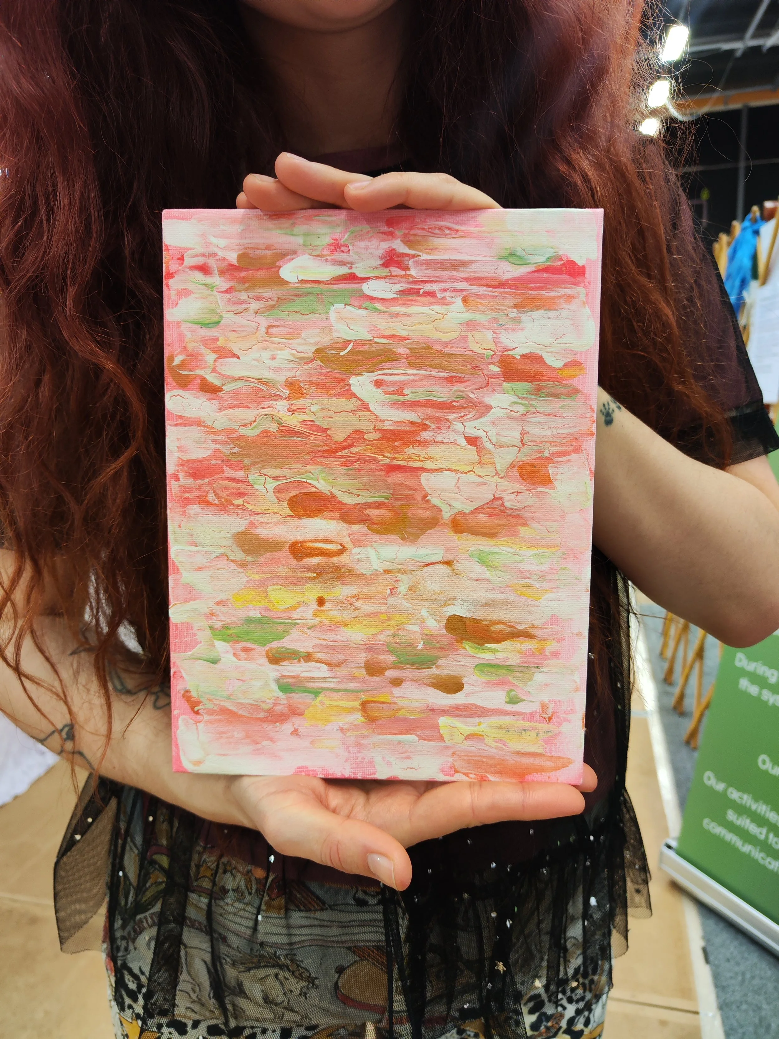Person holding their custom soul portrait, reflecting their energy, essence, and frequency in color and form.