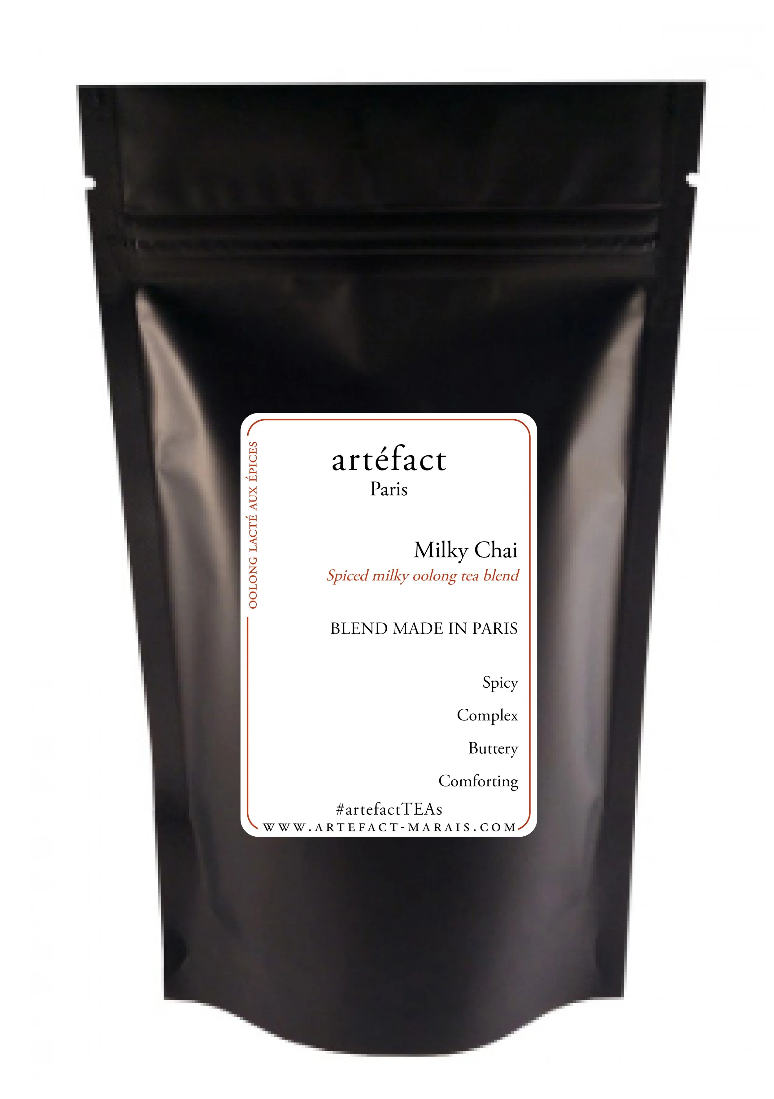 Black packaging pouch with a white label that reads 'artefact Paris Milky Chai,' describing a spiced milky oolong tea blend made in Paris.