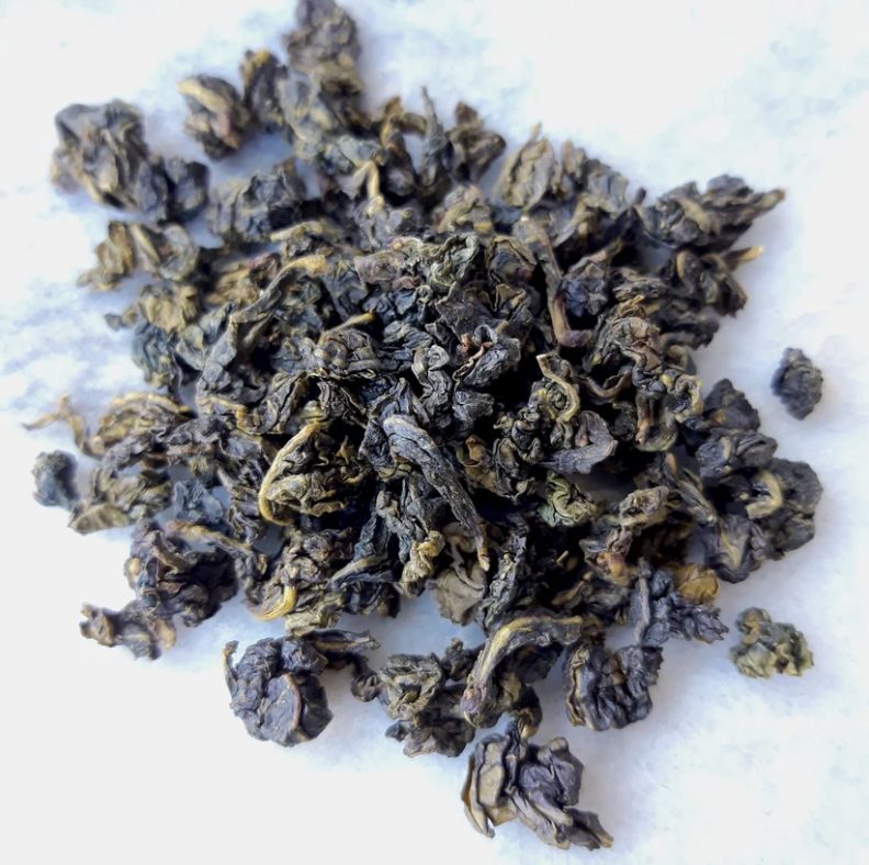 Dried loose tea leaves on white background.
