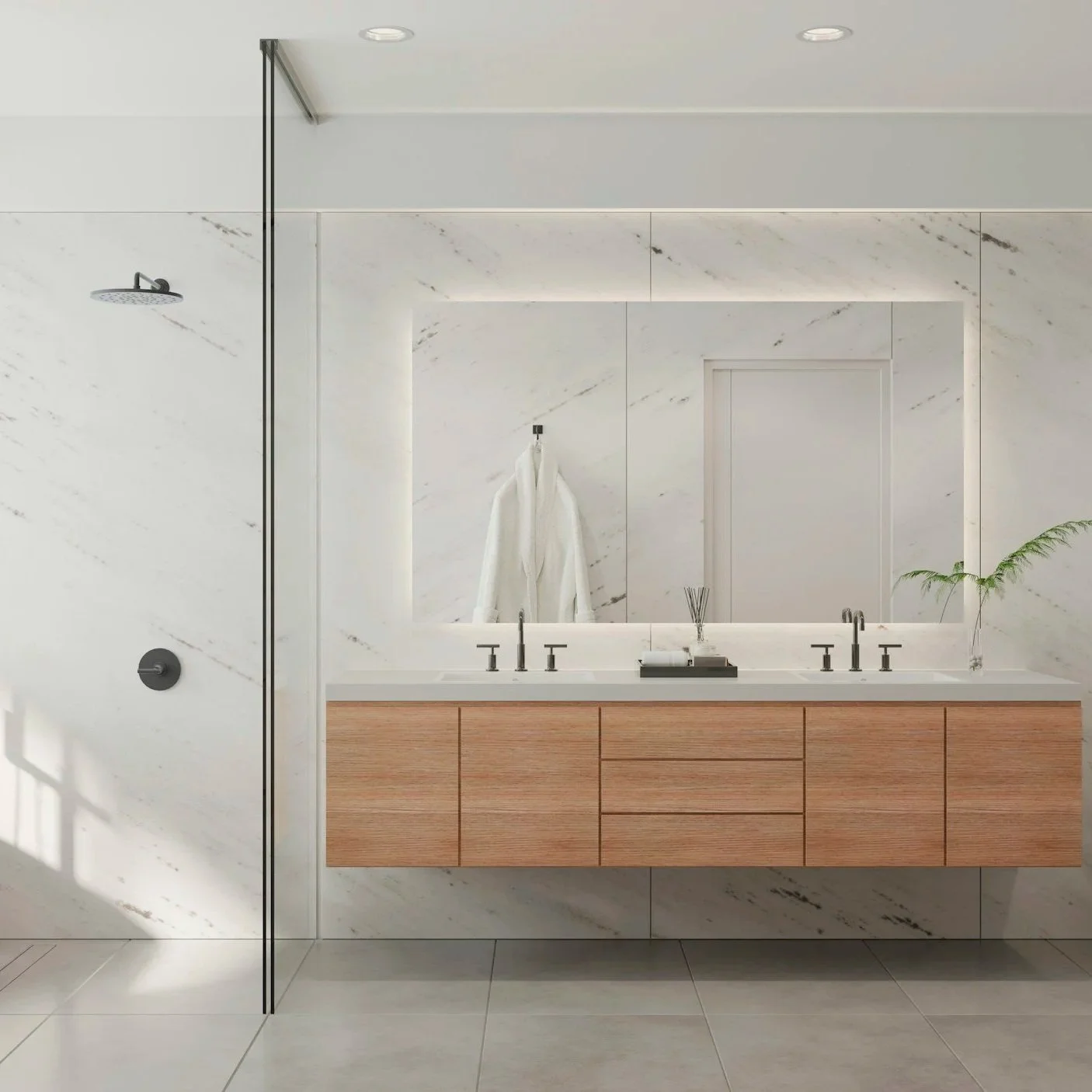 Modern bathroom with a large mirror, white marble walls, wooden vanity with dual sinks, a plant in a glass vase, and a towel hanging on the wall.
