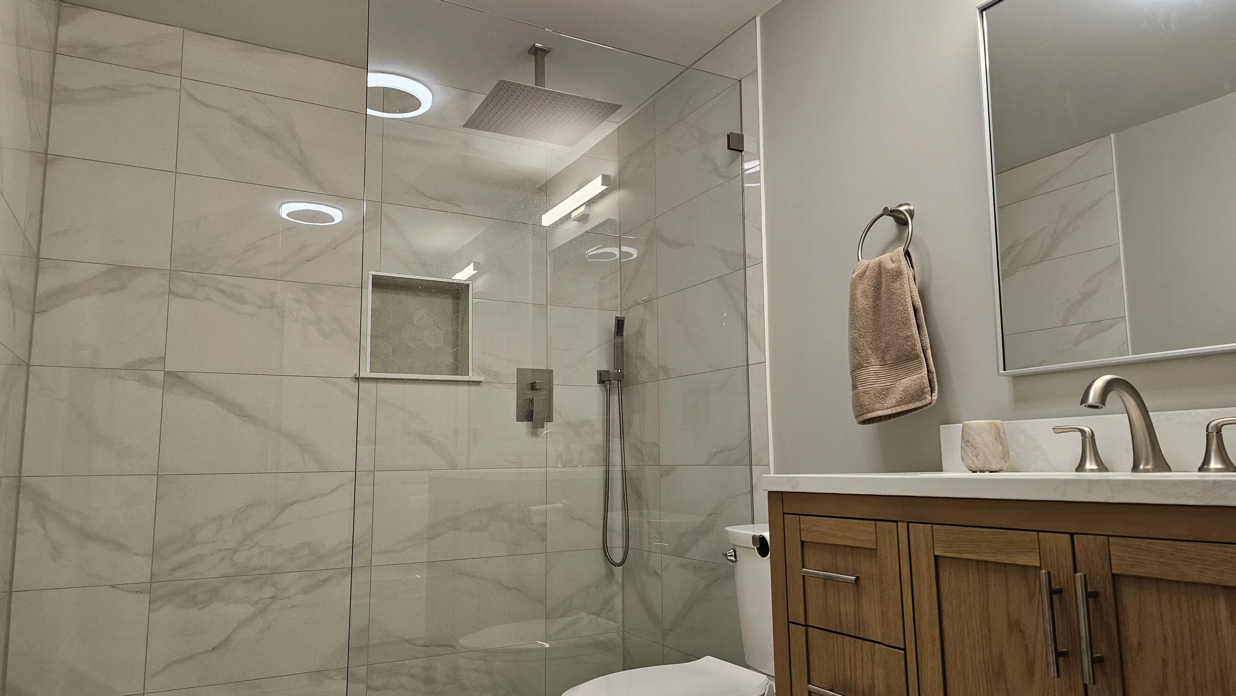 Beautifully finished basement bathroom in Crystal Lake with walk-in shower, modern tiles, vanity, and fixtures.