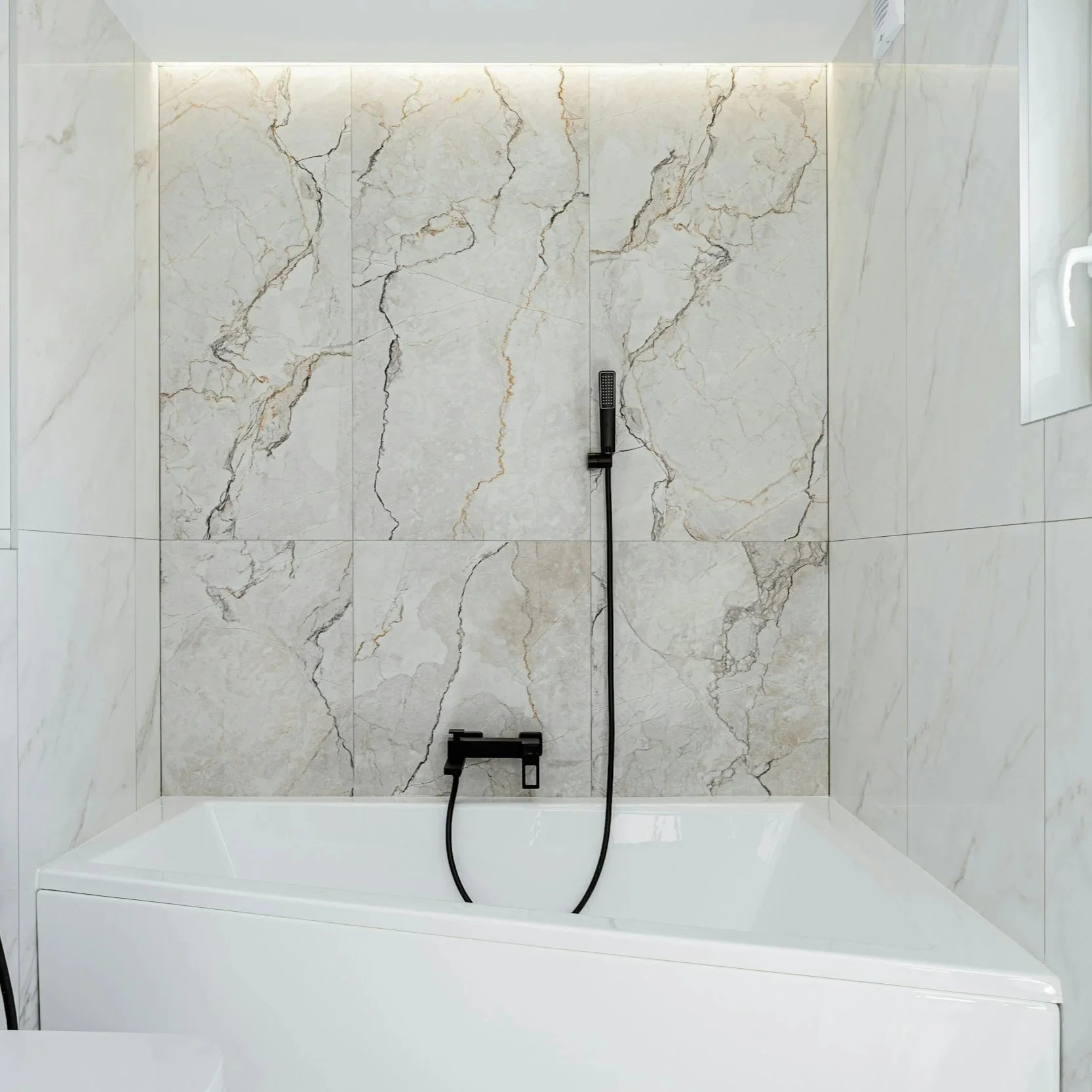 Modern bathroom with marble wall tiles and a built-in bathtub, featuring a black handheld showerhead.