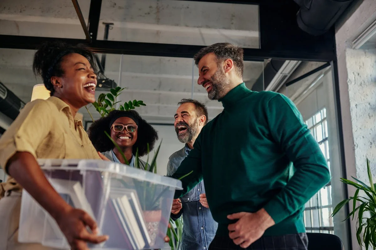 Coworkers greeting a colleague in a positive workplace culture