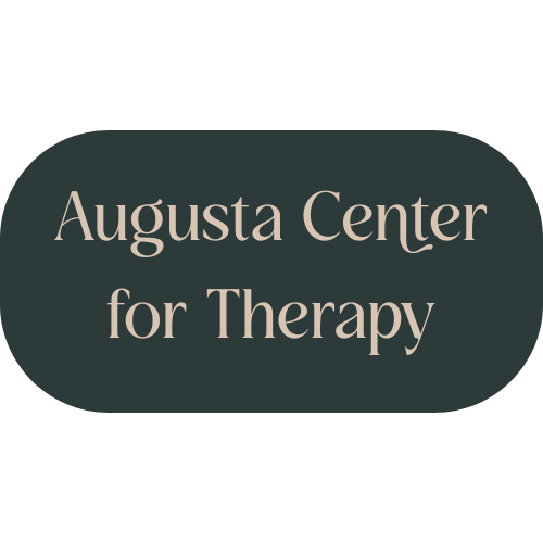 Sign with rounded dark background that reads 'Augusta Center for Therapy' in light-colored text.