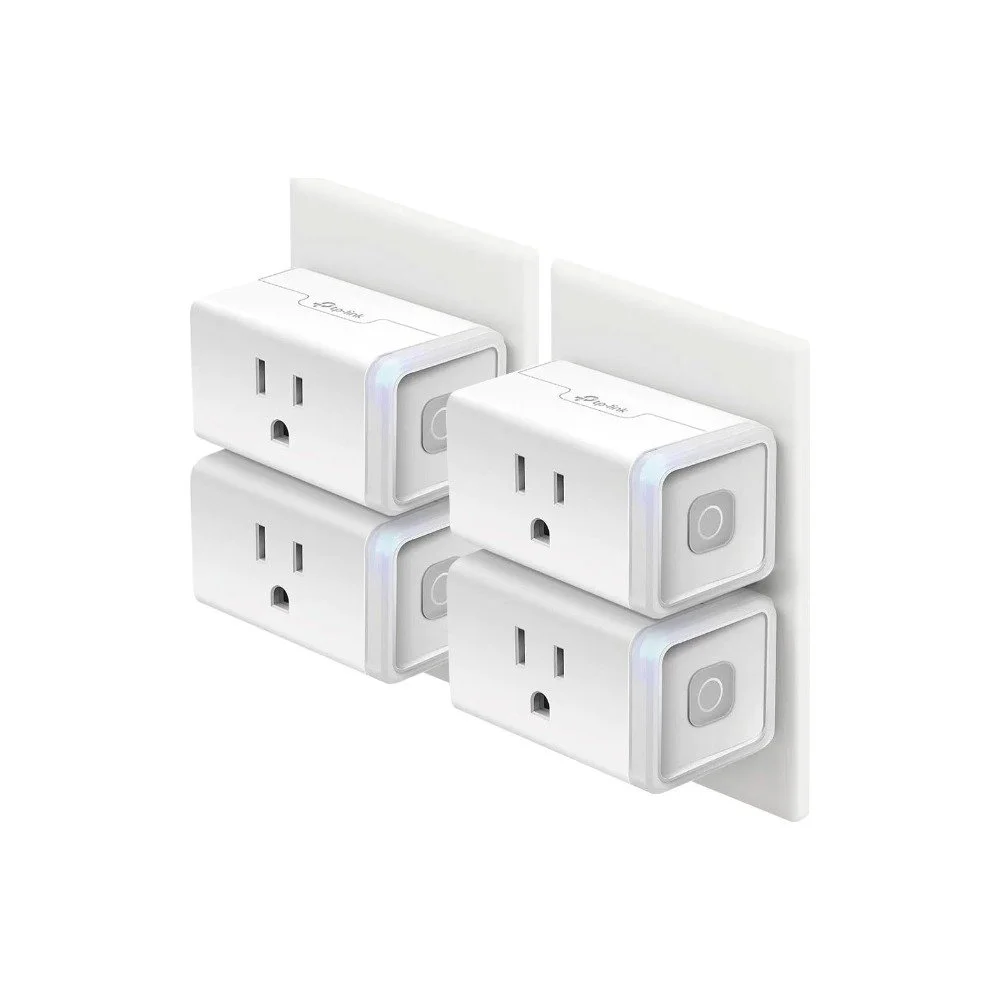 Four white Kasa smart Wi-Fi plugs plugged into wall outlets