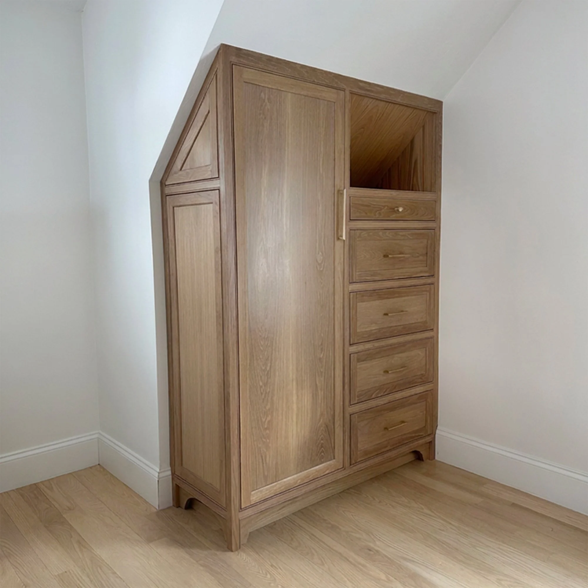 Custom white oak bedroom armoires designed to expand closet storage in a Newburyport, Massachusetts home.
