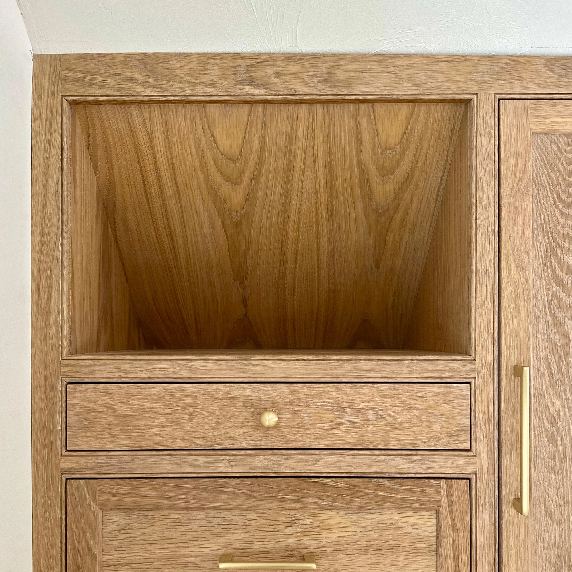Custom white oak bedroom armoires designed to expand closet storage in a Newburyport, Massachusetts home.