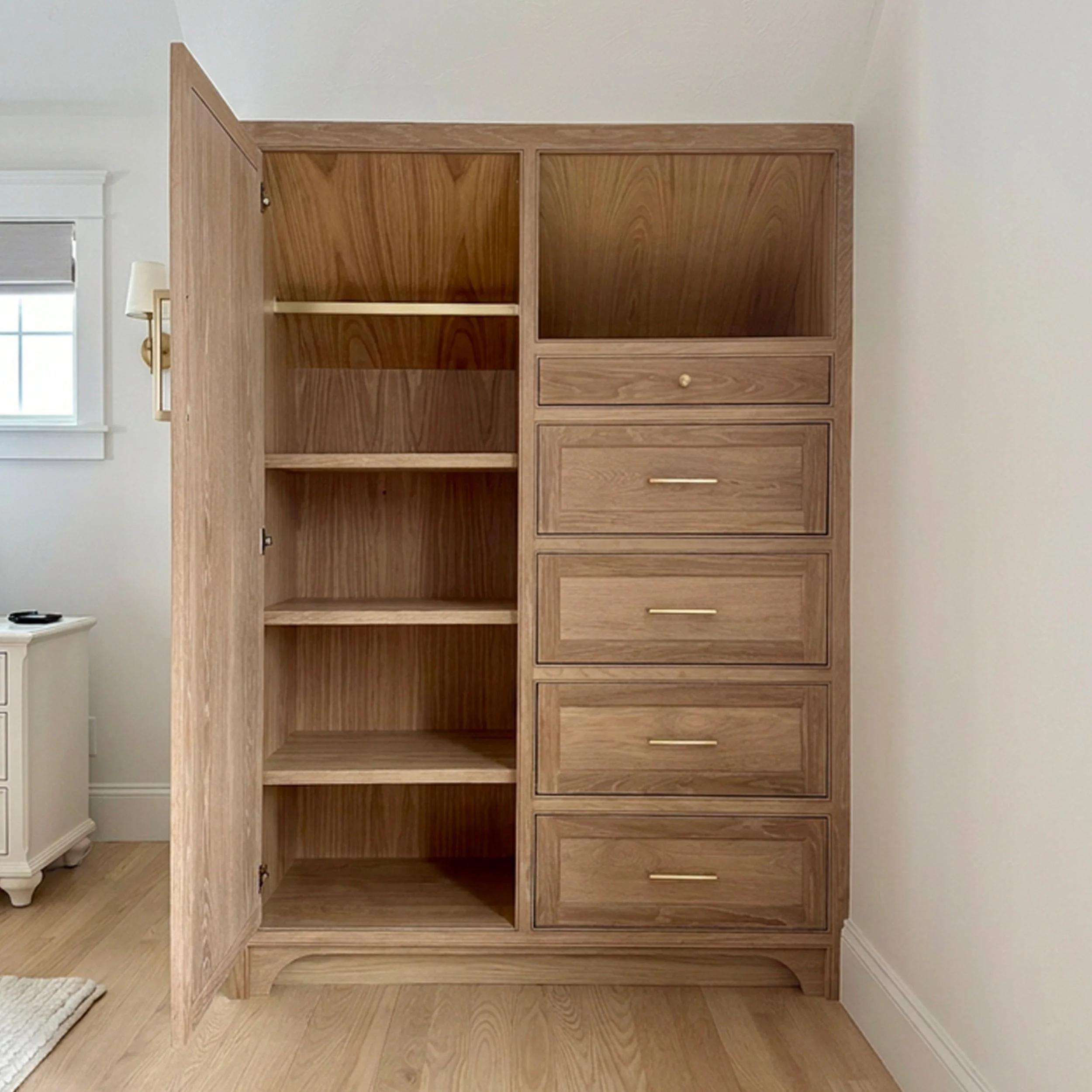 Storage | Custom white oak bedroom armoires designed to expand closet storage in a Newburyport, Massachusetts home.