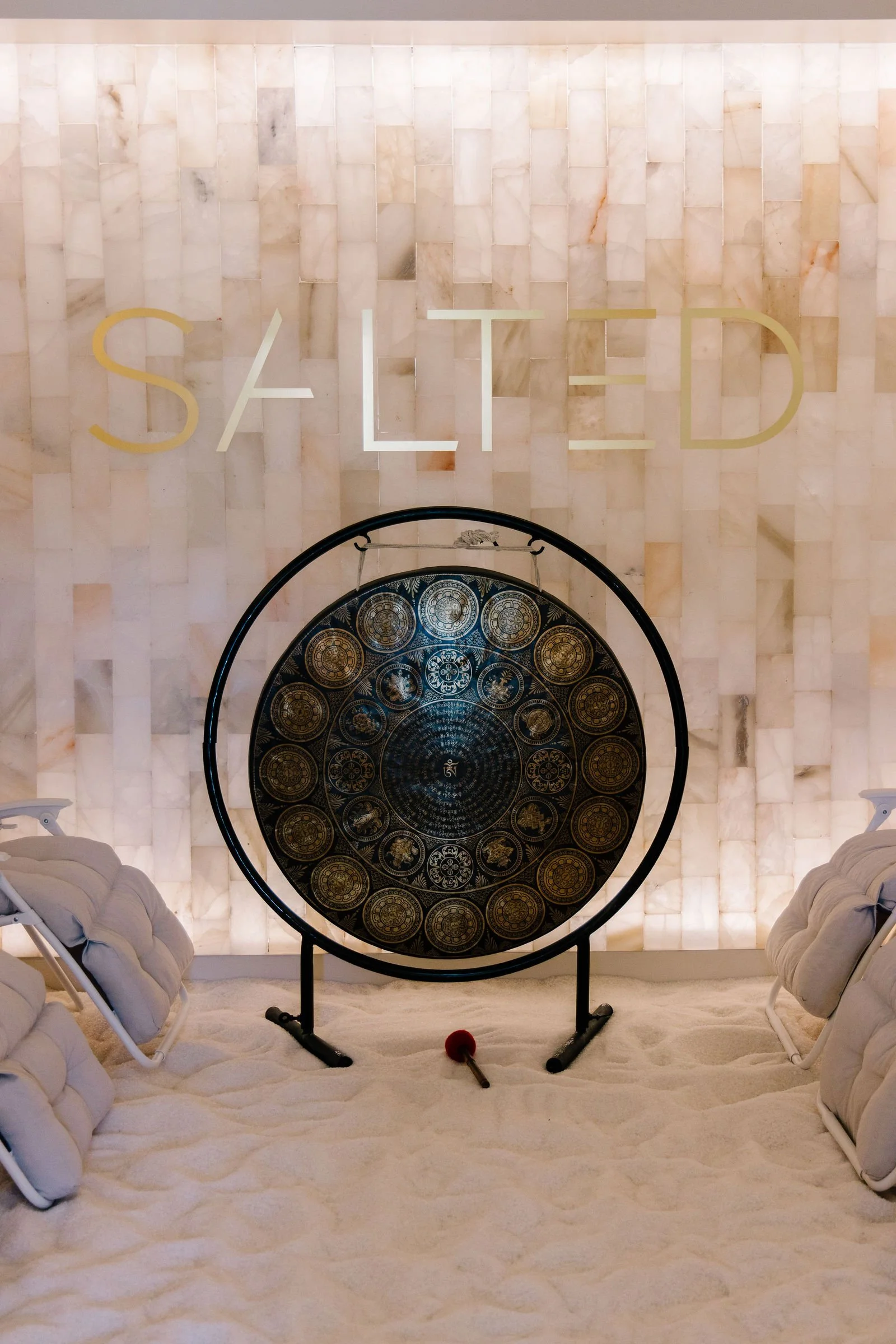 Gong in front of the Himalayan salt wall