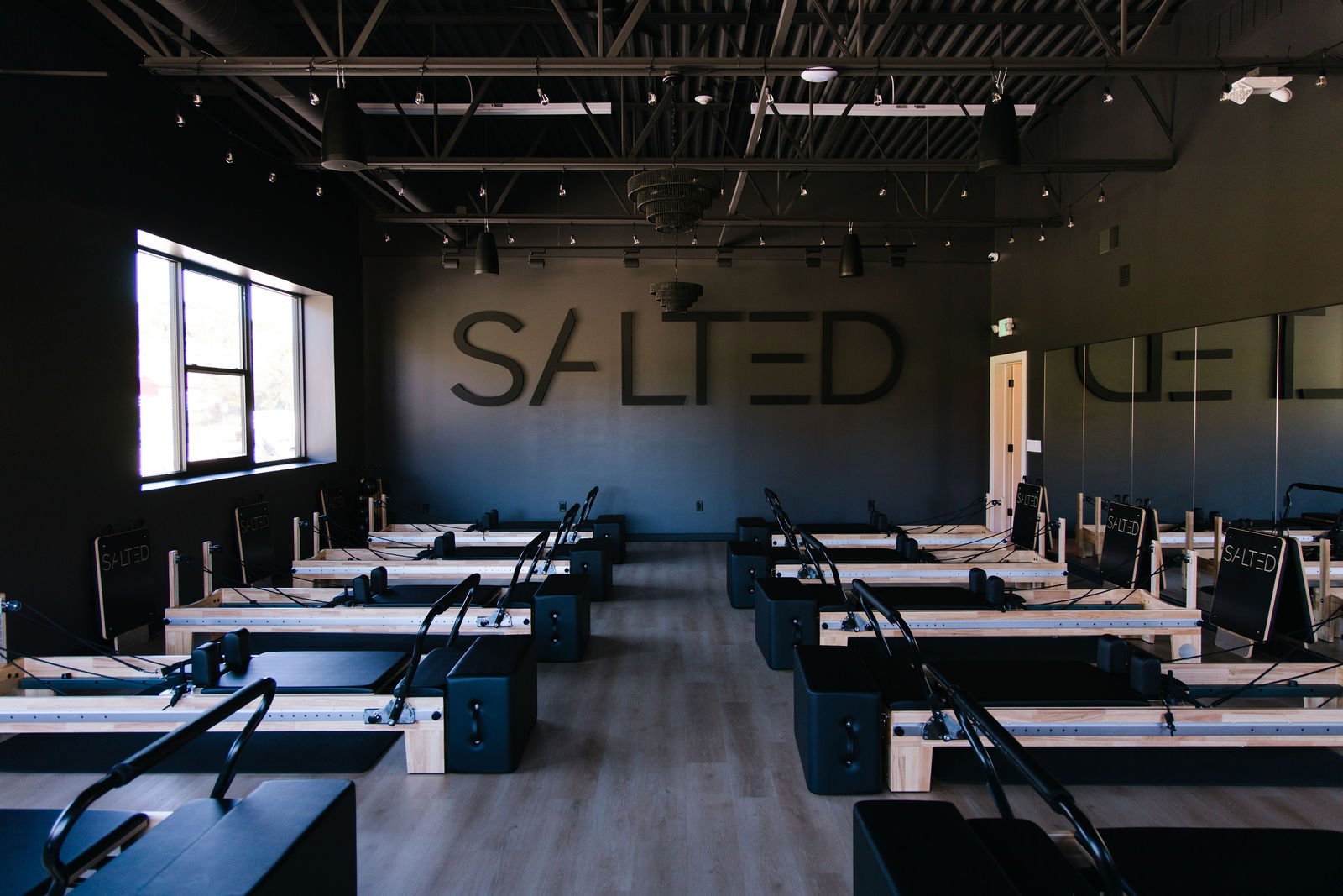 Reformer Pilates room with the SALTED wall logo