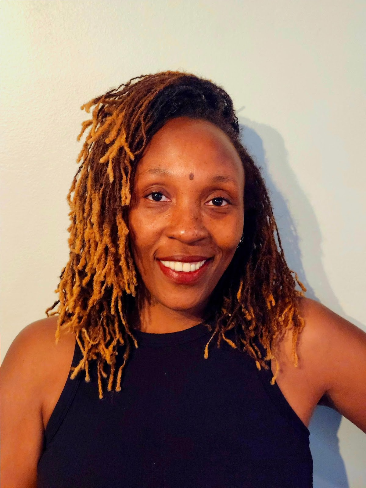 Close-up of green plants, moss, and small leaves in a dense forest floor scene.