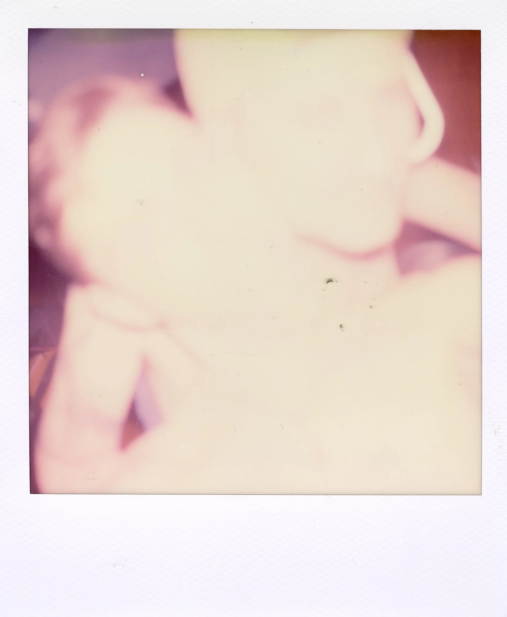 Close-up of a person's face, focusing on their lips and nose, with a finger touching their lips.