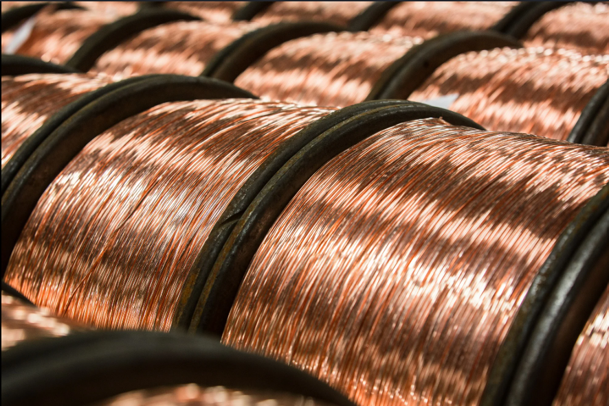 Close-up of metal spools wound with copper wire.